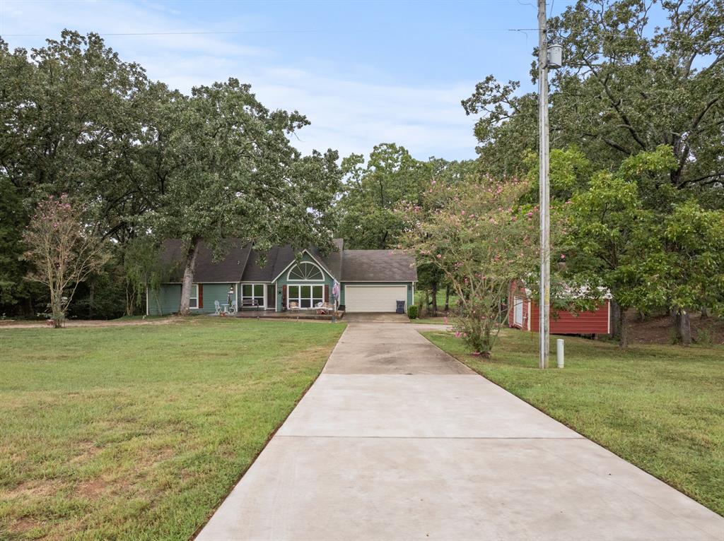 Nestled on almost 5 acres on a peaceful rural property. This versatile and well-maintained home offers the perfect blend of comfort, space, and functionality. This home has two bedrooms, two full bathrooms and an attached two car garage. Step inside to find high vaulted ceilings which provides country elegance with modern charm. Seller's pride of ownership in this one-of-a-kind home includes new HVAC system, newer hot water heater, new flooring, new windows, and a new patio deck in the backyard for all those cookouts and watching all that mother nature has to offer. The long concrete driveway to your front door adds to the convenience and accessibility not to mention value. Located in the highly acclaimed Chapel Hill ISD. Close in proximity to NTCC. (Northeast Texas Community College). Within minutes of your new home, you can also enjoy the lively downtown area of Mount Pleasant where you are sure to find a variety of shops and dining. Get your Boots on y'all and call for your private showing and come see what this is all about. New Survey. New foundation work, 06-07-2026.