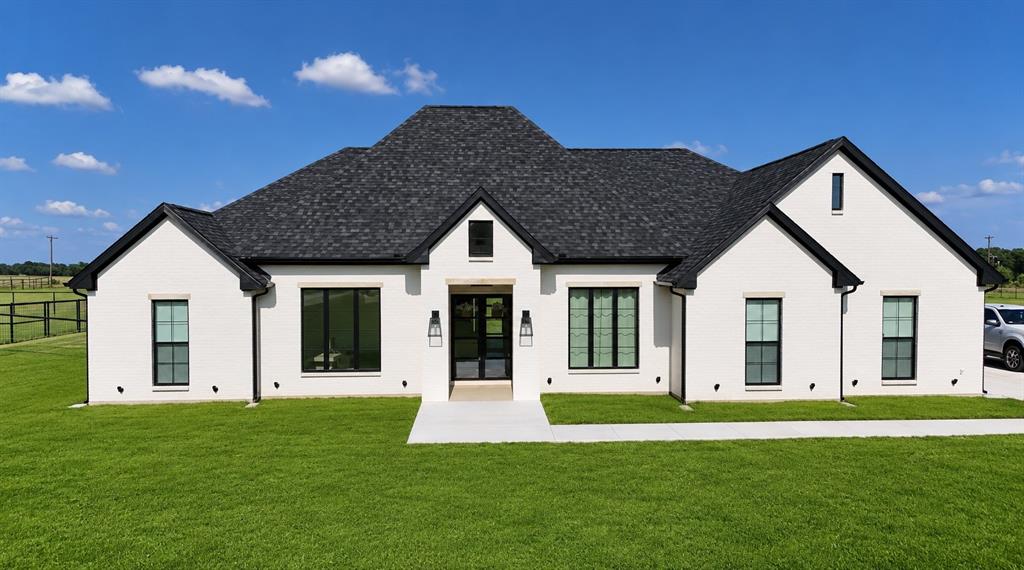Welcome to this stunning modern farmhouse built in 2024, perfectly situated on 1.30 acres with a long private driveway and a fully fenced backyard offering both space and privacy. Thoughtfully designed with 2,321 square feet of living space, this home blends timeless craftsmanship with elevated luxury finishes throughout.
Inside, you’ll find 3 bedrooms, 2 bathrooms, and an oversized office or flex room that easily adapts to your lifestyle. The open-concept living area showcases soaring cathedral ceilings, a beautiful cast stone fireplace, custom-sized windows, and wide plank flooring that create a warm yet sophisticated atmosphere. Ten-foot ceilings and 8-foot doors throughout the home add to the spacious feel.
The designer kitchen is truly the heart of the home, featuring custom inset cabinetry, two spice pull-out cabinets, a white oak island, farmhouse sink, polished nickel Perrin & Rowe faucet, polished nickel pot filler, and Rejuvenation hardware. Premium appliances include an 80in Bertazzoni panel-ready refrigerator, Forte panel-ready dishwasher, and a striking 48in white Hallman gas range, all included. Just off the kitchen, the oversized butler’s pantry with its own sink provides exceptional storage and prep space.
The primary suite offers a spa-like retreat with custom inset cabinetry, a large walk-in shower, tray ceilings, and luxury finishes designed for comfort and relaxation. Every bedroom includes its own walk-in closet, while the oversized laundry and mudroom adds everyday convenience.
Additional highlights include a spacious 2 car garage featuring an insulated 8-foot garage door and a dedicated Tesla charger outlet, providing both functionality and energy efficiency.
This exceptional property combines modern farmhouse charm with upscale custom details rarely found in today’s market.