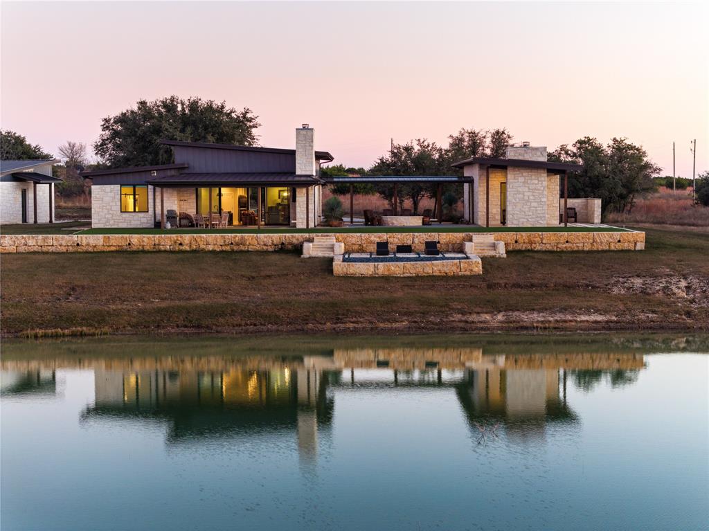 Set on 55.03 acres within the Rough Creek Lodge Resort, this modern Hill Country ranch estate offers a rare combination of acreage, water, and mountain views, paired with the convenience and lifestyle advantages of resort ownership.

With a combined 2,907 square feet, the property features three bedrooms and four baths, along with two bunk rooms that provide flexible accommodations for family and guests. The separate casita with kitchenette adds additional private space, creating a thoughtful layout that comfortably blends shared living with private retreats. The property also includes a massive 25x40 garage with three garage doors, ideal for vehicles, recreational equipment, and storage. The homes overlook a private lake, with the back porch designed as a welcoming gathering space complete with a fireplace and rocking chairs, perfectly positioned to take in tranquil water views, open pastures, and long vistas toward Gun Mountain.

Ownership includes access to Rough Creek Lodge and its approximately 9,000 acres of private ranch land, giving owners the rare ability to explore, hunt, and enjoy the property as if it were their own. From hunting opportunities and guided outdoor experiences to fishing, hiking, and seasonal activities, the land itself becomes an extension of home. At the center of the resort is the main lodge, featuring award winning fine dining in a stunning lodge setting overlooking Mallard Lake, along with inviting gathering spaces that define the Rough Creek experience. The resort’s concierge-driven service team also assists with coordinating activities, dining, and home-related services whether owners are enjoying the home or away, creating a truly effortless ownership experience.

This is a unique opportunity to own a furnished, lakefront ranch estate offering acreage, views, privacy, and the lifestyle benefits of one of Texas’ most celebrated luxury resort destinations.