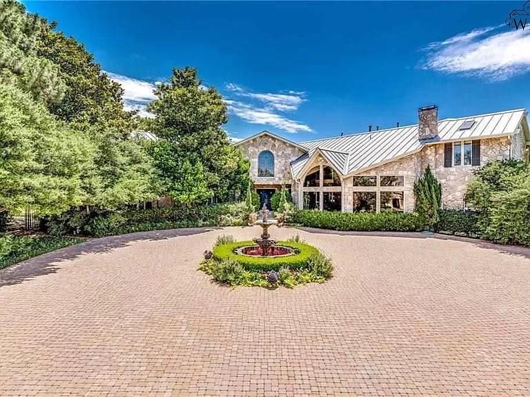 Countless walls of windows with panoramic views of a lake on Plano’s best lot welcome the outside into this magnificent custom country estate on over 4.6 acres. This stunning property includes a custom home (10,000 square feet), a separate guest house (840 square feet), a Pool, multiple Patio areas, outdoor Kitchen with serving bar, tennis court with covered viewing area, a waterfall that goes into a river, gardens, four active bee hives, and breathtaking landscaping. New roof & $500k in recent renovations.