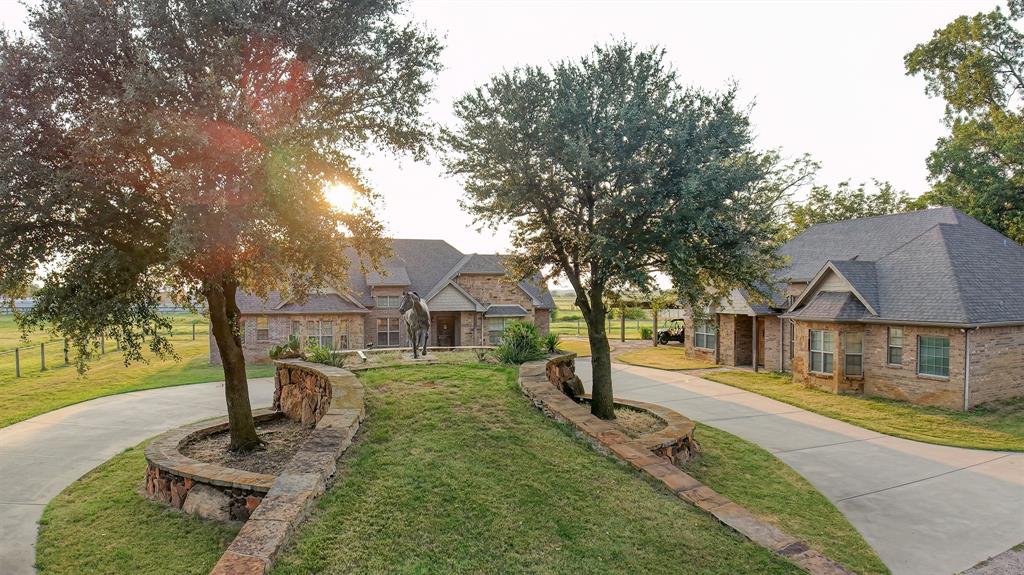 This 23-acre equine paradise offers TWO identical brick homes, each featuring three bedrooms, two and a half baths, and hardwood floors—perfect for multi-generational living, staff housing, or guest accommodations. A gated entrance with a long, tree-lined driveway sets the tone for this remarkable property, which also showcases an original Maritta McMillan equine statue as a focal point of arrival. The ranch is fully fenced and ag exempt, with 53 acres of hay pastures prime for development. Equestrian facilities include a show barn with 11x11 stalls and a brick alleyway, a massive 40’x100’ hay and storage barn, and a large shop with a three-carport. A separate barn is already prepped for completion as a mare motel, while over 20 spacious turnouts and a riding arena provide ample space for training and turnout. Combining functionality, space, and timeless beauty, this is a property you truly must see in person.