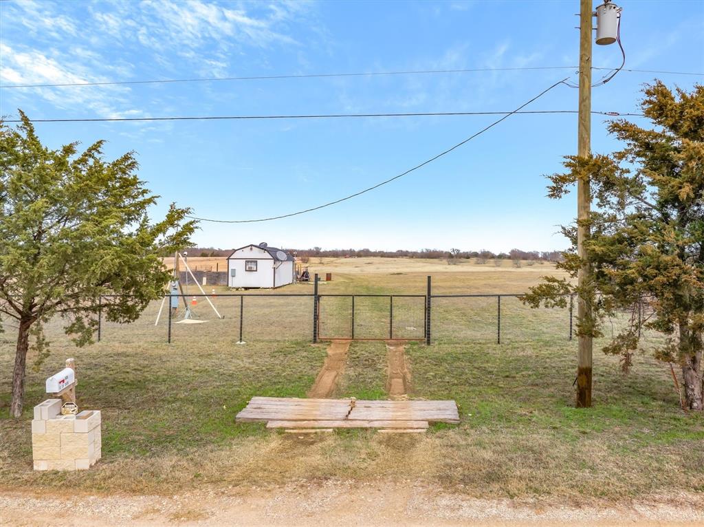 Looking for freedom, flexibility, and a place to make your own? 
This unique property sits outside city limits with no known deed restrictions, giving you the freedom to use the land the way you want (buyer to verify). Whether you're looking for a weekend escape, a place to spread out, or an investment opportunity, this property has plenty of potential.
Property has 5' no climb front fence and (2) entry gates. A 12' x 28' storage shed has been converted into living quarters, with established electric, making it a great option for temporary or weekend stays. Plus, a 40' high-cube shipping container provides tons of storage space for tools, equipment, or hobby use.
Enjoy the peace and quiet of country living while still being within a reasonable drive to town. Bring your ideas—this property is ready for your vision.