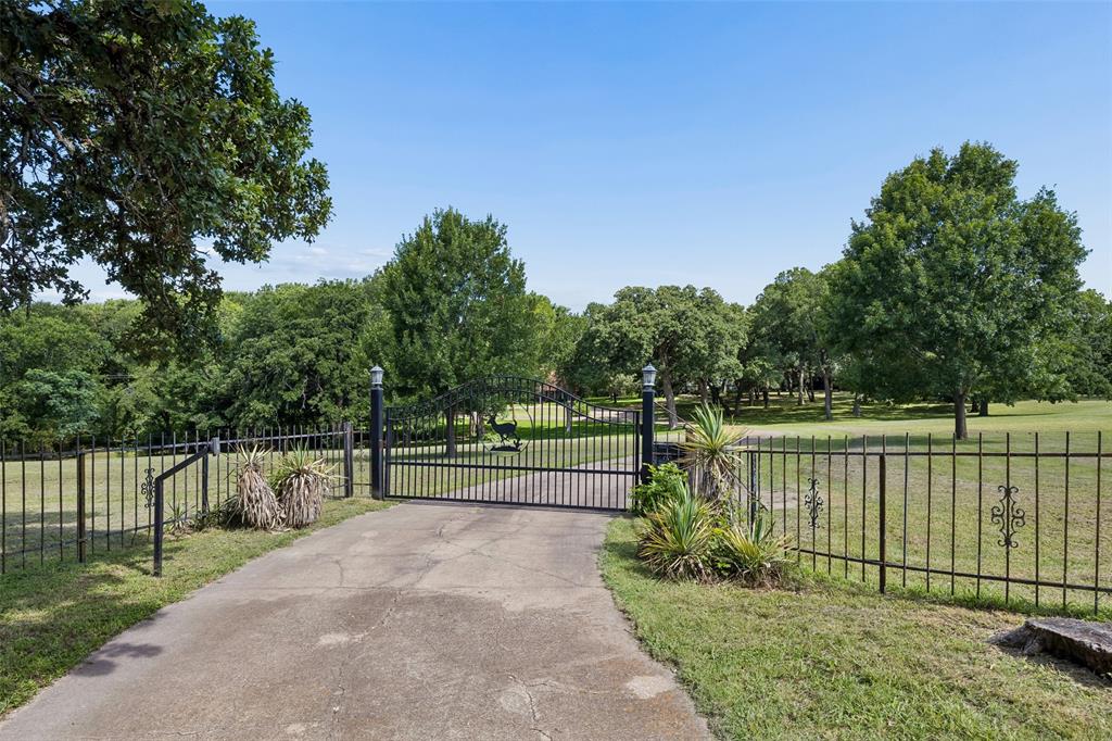 Experience the perfect blend of natural beauty, privacy, and refined luxury on this breathtaking 19+ acre estate in Southeast Dallas. Ideal for multi-generational living, future custom development, or a private retreat. This rare property offers endless possibilities. The meticulously maintained property features two fully stocked ponds, beautiful landscaping, and mature live oaks, elms, post oaks, and pecan trees. The pond-fed irrigation system keeps the property green and vibrant year-round. The over 4,341-square-foot main residence offers 4 bedrooms, 3 full baths, and 2 half baths. Each bedroom includes a walk-in closet and a private or shared en-suite bath, with a Jack-and-Jill layout. The primary suite is located on the lower level and features a private office and abundant storage. One cedar walk-in closet and additional storage throughout. Designed for entertaining, the stunning second-level great room features a wet bar and scenic views of the ponds. The family room features a wood-burning Chicago brick fireplace and a private balcony with views of the scenic grounds. A separate 1,200-square-foot guest house with its own gated entrance is located on the back side of the property. Additional amenities include a copper roof with Firestone finish, a huge 6-car garage with RV storage. This extraordinary estate combines comfort and breathtaking beauty with endless opportunities and is just minutes from Downtown Dallas. Second home included 601 Durham Rd.