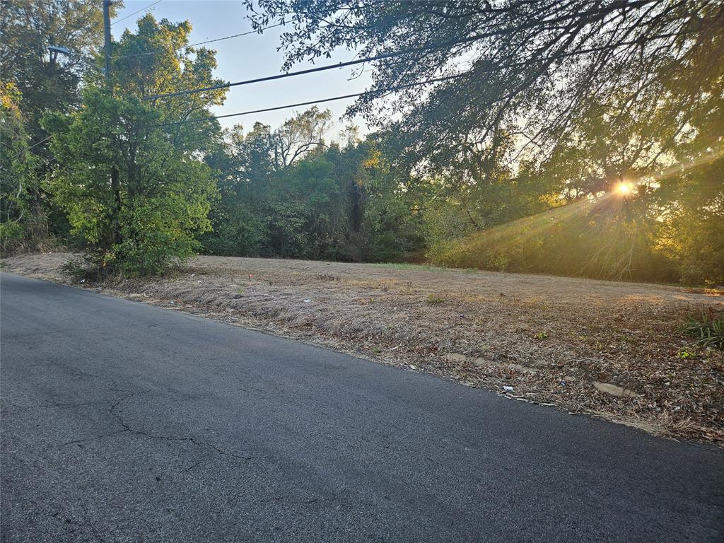 Prime 2.47-acre tract in the heart of Paris, TX! Located near downtown, this spacious property offers a rare opportunity to own acreage inside city limits. Mature trees provide natural privacy and shade, while the open areas create options for developing multiple homesites or investing for future growth. Convenient access to city utilities and paved frontage along 7th NW and also access to Graham Street!