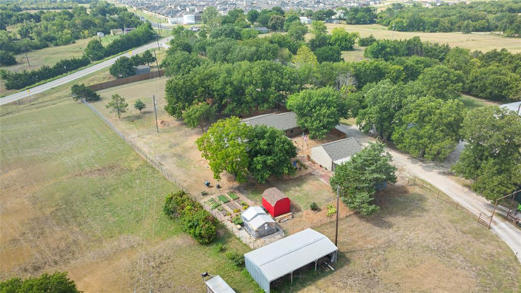 Rare 1.39-Acre McKinney Home with Two Primary Suites & 2023 Updates! Discover this beautifully updated 4-bedroom, 3-bath home offering the perfect combination of peaceful country living and convenient access to shopping and dining. This move-in-ready home is ideal for multigenerational living, guests or a flexible work-from-home lifestyle. The spacious Primary Suite Addition (2011) serves as a true retreat, featuring pocket doors, an oversized walk-in closet, a spa-inspired ensuite with a stand-alone jetted soaking tub, an expansive two-person slate walk-in shower, and the convenience of a second washer and dryer hookup. The spacious kitchen opens to a bright sunroom overlooking the scenic backyard, while the inviting living room features a cozy wood-burning stove. Outside, enjoy a 12x16 greenhouse, organic raised-bed garden, rebuilt lofted storage shed, detached two-car garage with adjoining carport, solar-powered flagpole, and a cedar board-on-board privacy fence with beautiful views beyond. Equally impressive are some major improvements completed in August 2023 for the next owner's peace of mind, including a new roof, new 14.3 SEER HVAC system, new electrical panel and completely re-insulated attic spaces, providing improved comfort and energy efficiency. If you've been searching for a McKinney home on acreage, a move-in-ready property with two primary suites, or a country home near city conveniences, this exceptional property is ready to welcome you home.