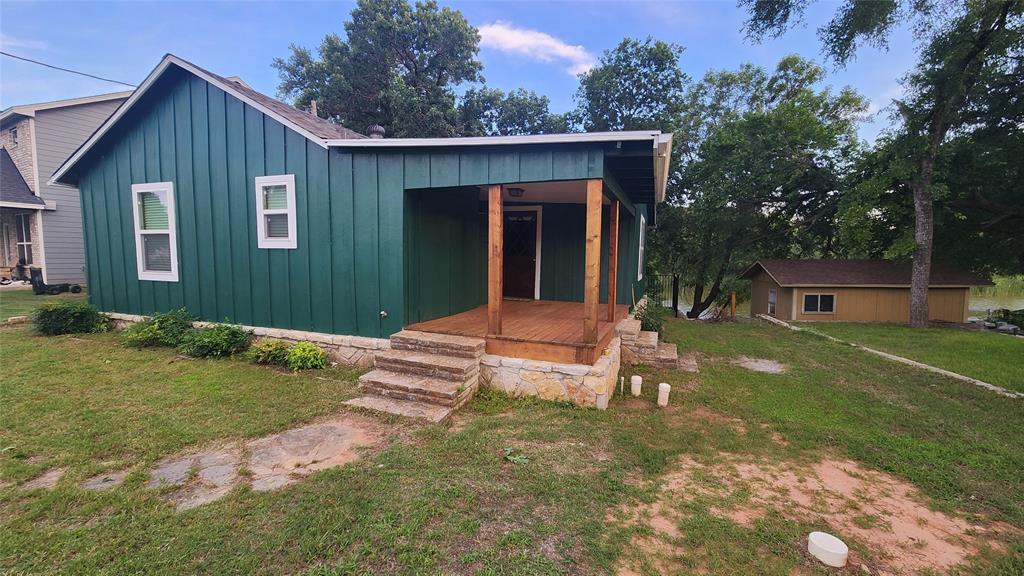 Escape to the lake and enjoy the laid-back lifestyle that this charming waterfront cabin offers. Located on Robinson Creek with quick access to the main body of Lake Granbury, this cozy retreat is ideal as a weekend getaway, income producing short-term rental, or full-time residence. Additional features include a sunroom with a free-standing stove and a bar area as well as a dock with great fishing. Roof, windows and siding replaced in 2025. New appliances in 2025. Interior remodeled in 2025 that included plumbing, flooring, cabinets, and upgrade to 200 Amp service. New septic and HVAC installed in 2022. Furnishings can be included in purchase for a turn-key rental or vacation home!
