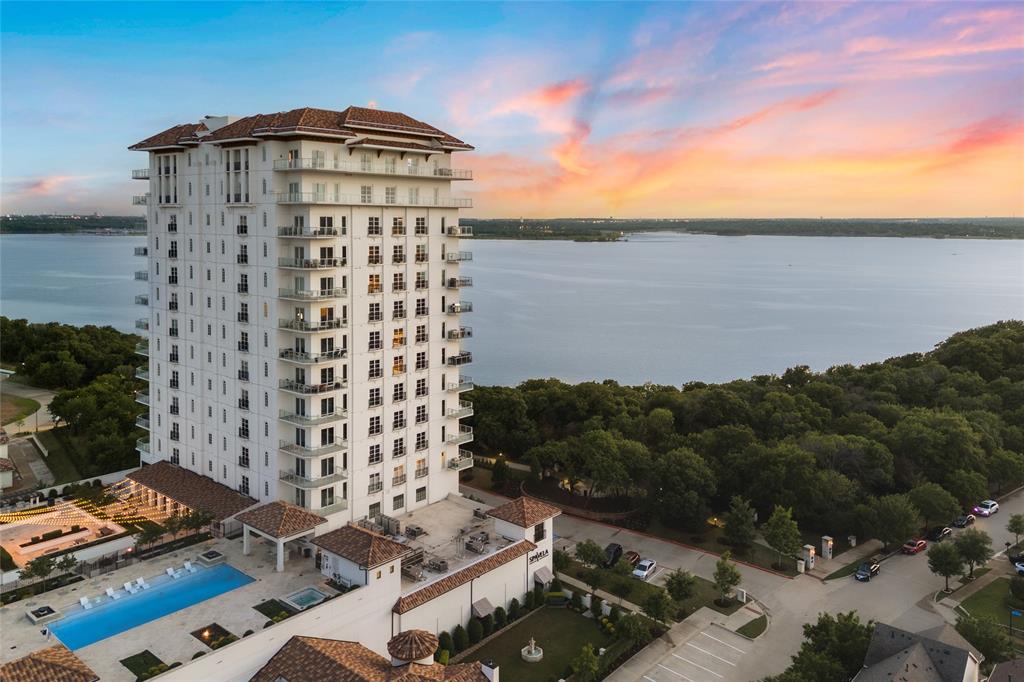 Experience Flower Mound Lakeside luxury living like never before at Lakeside Tower overlooking Lake Grapevine, where sophistication meets serene, resort-style living. This stunning condo offers sweeping, unobstructed views of the lake— breathtaking sights! Imagine waking up each morning to sparkling water views and ending your evenings with colorful sunsets that feel like private paintings just for you. Step inside into your home from a direct access elevator to discover an elegant, open-concept layout designed with both comfort and style in mind. High-end finishes, and expansive windows flood the space with natural light, highlighting the thoughtful design and attention to detail throughout. Whether you’re relaxing in the spacious living area, entertaining guests in the gourmet kitchen, or enjoying quiet moments on your private terrace, every space has been crafted to embrace the beauty of lakeside living. Beyond the walls of your residence, Lakeside Tower offers an array of first-class amenities that make everyday life extraordinary. Sharpen your game in the state-of-the-art golf simulator room, stay active in the fully equipped fitness center, or unwind by the resort-style pool. The concierge is available to cater to your every need, offering true lock-and-leave convenience and peace of mind. Just steps away, Lakeside Village invites you to explore a vibrant community filled with premier dining, boutique shopping, entertainment, and charming walking trails — all easily accessible without ever having to leave the neighborhood. At Lakeside Tower, you’re not just purchasing a condo — you’re embracing a lifestyle of beauty, convenience, and exclusivity on the water. If you’ve been searching for the perfect combination of luxury, location, and memorable views, welcome home.
