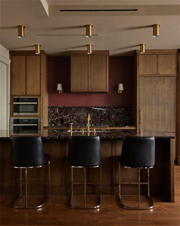 Luxury FULLY FURNISHED residence now offered at $1,299,000 in the iconic Bleu Ciel. Located at 3130 N Harwood St #1502, this designer-curated 2-bedroom, 2.5-bath home by Joshua Bernard showcases elevated, bespoke interiors with striking Rosso Levanto marble, moody Moroccan clay walls, and timeless custom finishes throughout. Appointed entirely with Waterworks fixtures and hardware, every detail reflects refined craftsmanship and sophisticated design.

Floor-to-ceiling windows flood the residence with natural light while framing sweeping city views. The open-concept living and dining spaces flow seamlessly into a sleek chef’s kitchen designed for both effortless entertaining and everyday luxury. Both spacious bedrooms feature en-suite baths, complemented by an elegant powder bath for guests.

Residents of Bleu Ciel enjoy world-class amenities including 24-hour concierge and valet, resort-style pool, state-of-the-art fitness center, spa and sauna, wine lounge, and beautifully designed common areas. Perfectly positioned in the prestigious Harwood District with walkable access to premier dining, luxury shopping, and the Katy Trail.

A rare opportunity to own lock-and-leave sophistication in one of Dallas’ most sought-after luxury high-rise residences.