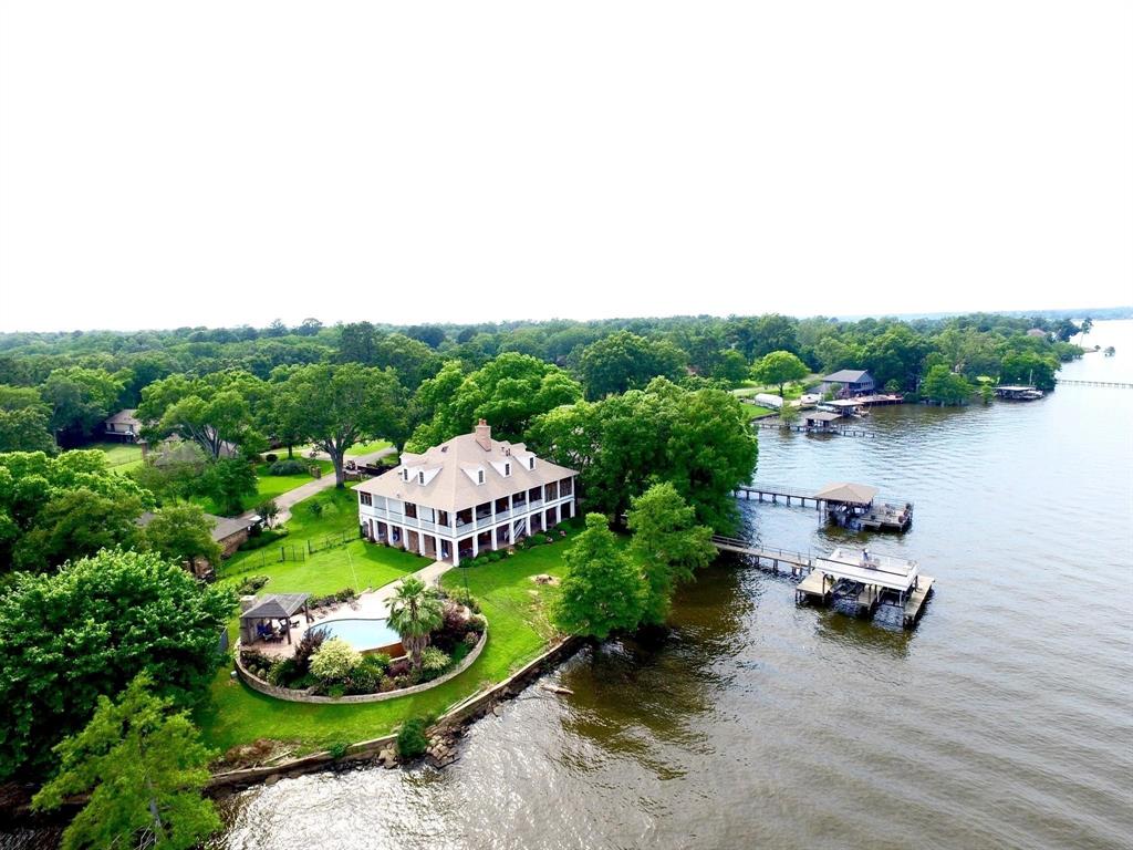 Beautiful custom built Crosslake Plantation style home with lake view, full two stories, each level has its own kitchen, master suite, guest room and living room etc. Total offers 4 large bedrooms, 4 full baths, 2 kitchens, and 2 living areas and a private office with a beautiful lake view. Open floor plan, cathedral ceiling, Second floor kitchen has commercial built-in side by side freezer, refrigerator. Commercial size range-oven. Separate ice maker. Master suite with fireplace. Property is sitting on 0.75 acres. Boat house with two boat lifts and a large party deck on top. Gorgeous pool area with
an outdoor fire place and a pergola, outdoor shower. Did I mention 3 fireplaces plus one at the pool? Please give one day ahead of time for schedule showing, prequalification letter must be sent to agent before showings.