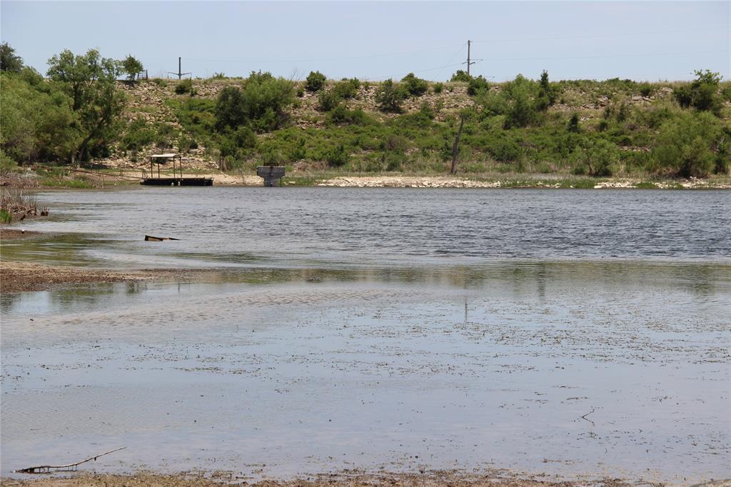 REDUCED! PRIVATE LAKE WATERFRONT LOT! THIS IS LOT 3. Come enjoy some peace and quiet on this private lake. This lot offers you a country atmosphere although it's just minutes away from all that Brownwood has to offer. 1.99 acre tract has some Oak Trees, and scrub brush that can easily be cleared for that perfect building site. Light restrictions allow traditional construction style homes, Barndominiums, Single Wides, Double Wides and even RV's are allowed on this lot! It can also be used as an overnight rental opportunity. Hurry before someone else takes this lot and opportunity from you!