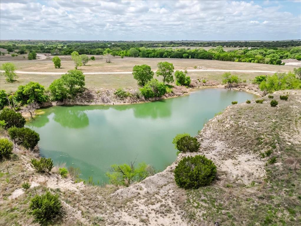 Everyone knows the three most important things in real estate are location, location, location—and here it is. Just minutes from I-20 and downtown Weatherford, this remarkable 396-acre tract offers a rare opportunity to own a legacy piece in the heart of Parker County. With four large water features, scenic Sanchez Creek frontage, and a beautiful mix of scattered hardwoods, the land delivers both natural beauty and functionality. The varied terrain creates depth and character, offering elevated views, privacy, and endless possibilities. Whether you envision a premier ranch, recreational retreat, or a long-term investment, this property has the potential to become one of the most stunning ranches in the area. For those looking at future development, the extensive road frontage on Bethel Road provides strong accessibility and flexibility for subdivision or planned development. If considering a commercial or mixed-use development, a turn lane is already in place, adding valuable infrastructure and ease of access. Water is a standout feature, with two high-producing wells already in place—one producing approximately 20 gallons per minute and the other an impressive 60 gallons per minute—supporting both residential and agricultural use. Properties of this size, location, and versatility are rare. This is Parker County land at its finest.