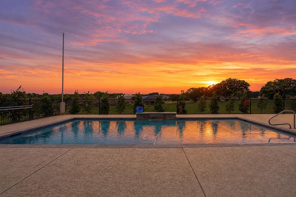 Summer is around the corner & it's time to relax by the pool & take in the gorgeous views from this stunning Couto home! Situated on an elevated lot & over an acre in size, this four bedroom, three bath home PLUS Office ( or 5th Bedroom) AND Media Room offers an open floor plan, over $12k in custom window coverings, beautiful stone fireplace, granite countertops throughout & much more! As you enter the home, you are greeted with a beautiful iron door entry, coffered ceilings in the living room, stone fireplace & wall of windows overlooking the Texas landscape. The kitchen is a chef's dream with a BOSCH high end cooktop, 6 month old Kitchen Aid true convection double ovens & air fryer, 6 month old Kitchen Aid dishwasher, plenty of cabinets for storage & large breakfast bar. The master bedroom is spacious & the master bath has stunning, modern tile work surrounding the large soaker tub & walk-in shower. Enjoy your summer days outside on the covered back patio listening to the waterfall or take a dip in the pool to cool off from the Texas heat!