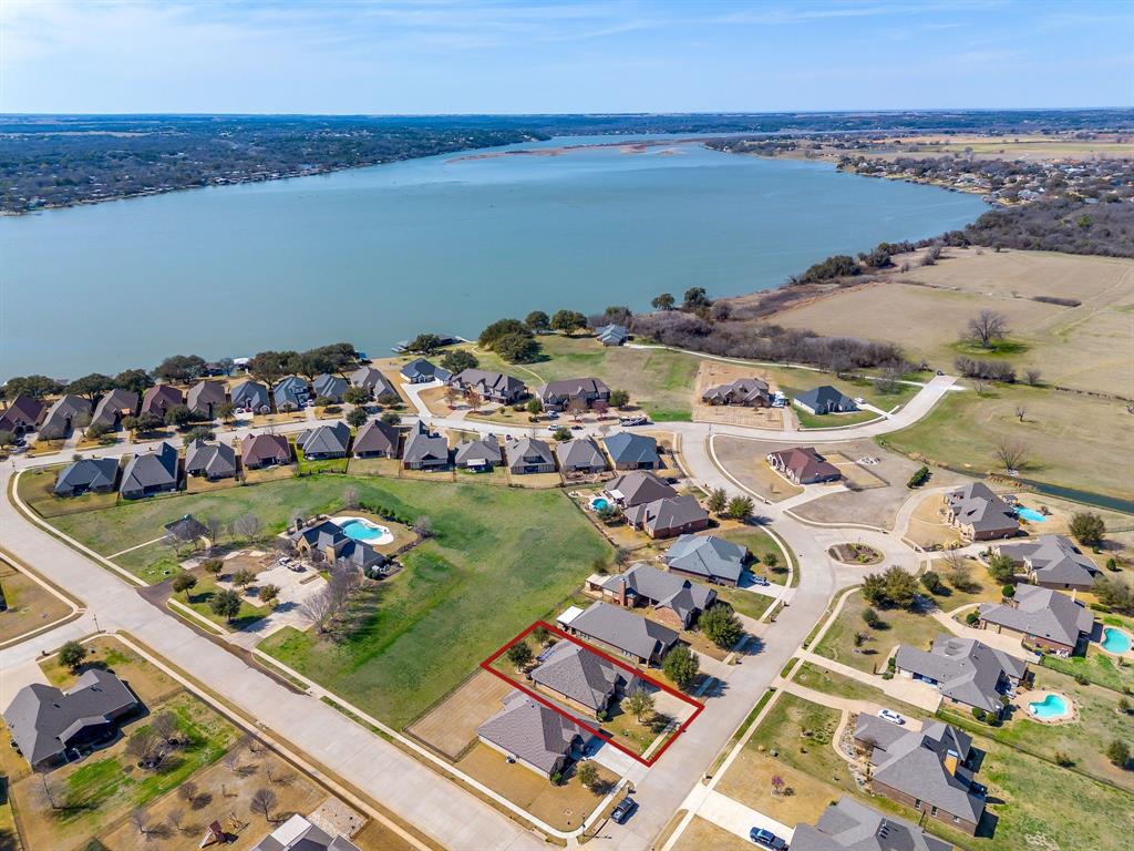 MOTIVATED SELLER: PRICE REDUCTION AND BUYER INCENTIVES!
Beautifully Upgraded Home in Gated Abe’s Landing with Greenbelt & Pool Access!
Welcome to 3303 Ferry Boat Lane, located in the sought-after gated community of Abe’s Landing, this exceptional single-story home is perfectly positioned with the neighborhood pool and greenbelt directly behind the property, offering convenient access and a peaceful backdrop.
Inside, you’ll find this 3-bedroom, 2-bath home with a private office that can easily serve as a 4th bedroom has 2,282 square feet of thoughtfully designed living space featuring soaring ceilings, engineered hardwood flooring throughout the main living areas, and an open-concept floor plan ideal for both everyday living and entertaining. The spacious living room showcases a dramatic cathedral ceiling and flows seamlessly into the oversized eat-in kitchen, complete with a large center island, gas range, abundant cabinetry, and generous counter space.
The private primary suite is a true retreat, featuring a beautiful tray ceiling, abundant natural light, and a luxurious ensuite bath with a jetted soaking tub, separate walk-in shower, private water closet, and an oversized walk-in closet.
Enjoy outdoor living year-round on the covered back patio with privacy screens overlooking the landscaped, fenced backyard and direct access to the community greenbelt and pool.
Additional upgrades include a new HVAC system, epoxy-coated garage floors, built-in workbench and tool storage, spacious utility room with cabinetry and folding counter, seven-zone sprinkler system, and dual water softeners.
Located in the heart of Granbury, you’ll enjoy the charm of historic downtown, shopping, dining, entertainment, Lake Granbury, and easy access to everything this thriving community has to offer. This move-in-ready home offers the perfect combination of comfort, quality, and an exceptional location.