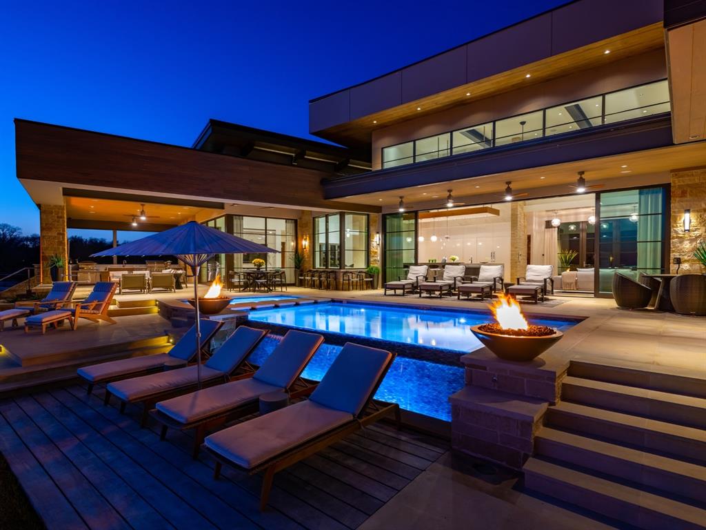 One of a kind Luxury MODERN SMART HOME featured in Houzz website and Modern Luxury Interiors Magazine! LAKEFRONT AMAZING Open Water views! Located in E. TX Golf Community. Envision a 30ft wide view of the INFINITY POOL and massive LAKE when entering the home. Guests will marvel over your 10ft WATERFALL style  ISLAND covered w Grey, white QUARTZ COUNTERS, WHITE European cabinetry. 3100sqft of OUTDOOR LIVING includes KITCHEN, FIREPLACE, and many choices of seating areas for a large guest list. HotTub w Hot-Cold-Self-Cleaning allows for yr round enjoyment. THIS home has hard to find high-speed INTERNET W automated LUTRON LIGHTING, SOUND, SECURITY, NEST THERM. Guest Retreats offer comfortable accommodations for 12!