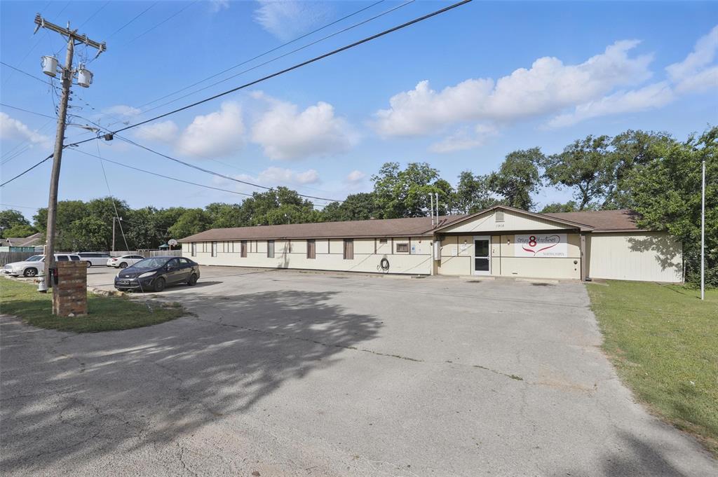 Placed in Cleburne's commercial-industrial flex district this building has great potential for a myriad of uses. Currently being used as a non profit shelter with 12 rooms, each with adjoining bath rooms and flexibility to house families in one wing. The second wing has 11 office and storage spaces that allow for interior walls to be moved, and as best as the seller's knowledge are not load bearing. This property has a large main kitchen with commercial vent hood and capability for a commercial range. An overhead fire sprinkler system has been installed as well. A large common area with a playground currently occupies the lot, you will also find a generously sized parking area and approximately 300 feet of road frontage.  Conveniently located just off of 174 and Highway 67 in northern Cleburne.