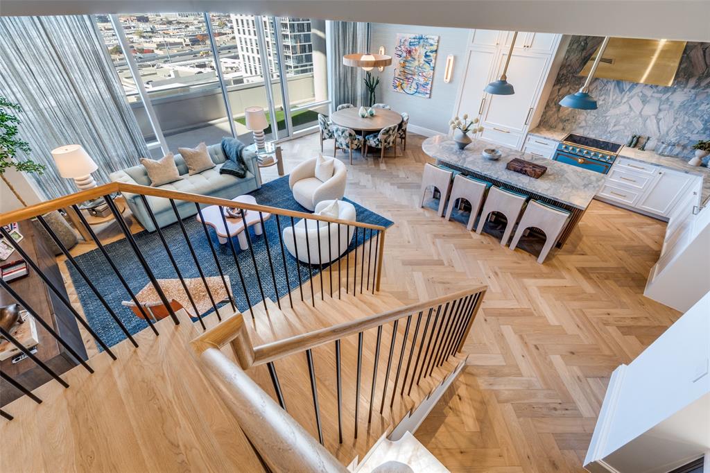 Attention to detail defines this stunning penthouse-level residence in the W Dallas South Tower. Offered fully furnished, this essentially brand-new condominium was completed in 2025 following more than two years of thoughtful, seller-driven custom build-out, with no expense spared to create a highly functional and luxurious floor plan. Highlights include Herringbone European white oak hardwood floors flow throughout the home, complemented by a versatile den ideal for a home office or additional guest room. The chef’s kitchen is a true showpiece, featuring a custom-colored La Cornue French induction range, custom brass metal hood, Sub-Zero refrigerator, and an oversized natural stone island, all seamlessly open to the living area for effortless entertaining. A striking bar area showcases a Cristallo countertop and backsplash, along with a Sub-Zero under-counter beverage refrigerator.The primary suite is a serene retreat, highlighted by grasscloth wallpaper and a spa-inspired bath with marble countertops and a matching marble shower. A dedicated coffee bar with under-counter Sub-Zero refrigeration and a custom-built walk-in closet complete the suite. The spacious guest suite offers its own ensuite bathroom for added privacy. Enjoy outdoor living on the oversized terrace overlooking Victory Park.
Further enhancements include include Lutron lighting throughout, electric shades, and custom drapery, Sonos speakers in every room, LED recessed lighting throughout, custom doors, and designer decorative light fixtures to name a few. The residence includes two assigned parking spaces and offers a true lock-and-leave lifestyle.Ideally located, step outside to premier shops, restaurants, American Airlines Center, Katy Trail, museums, Klyde Warren Park, Uptown, and the Goldman Sachs building.