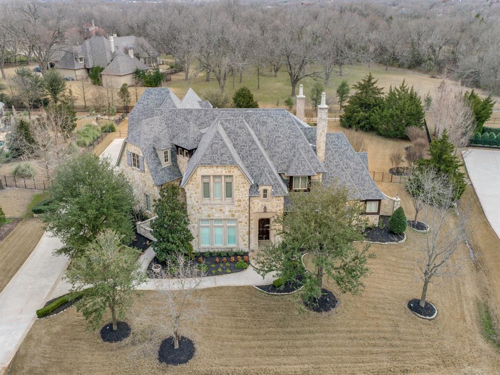 This exquisite home boast new nailed down hardwoods in entry, dining, study, living, master, kitchen & breakfast area. Elaborate dining room with new Plantation shutters & coffered ceiling. Expansive living room with vaulted wood beamed ceiling, FP & bookcases open to charming kitchen featuring brick ceiling, granite counters, built-in fridge, farm sink, warming drawer & gas cook-top. Massive master suite with FP, two toilets & double sided shower. Upstairs includes secondary master suite with his & her closets, game room & media room. All 6 bedrooms have ensuite baths. Inviting sun-room with FP overlooking large patio with water feature, covered patio & gas grill. All surfaces freshly painted! 4 Car Garage!