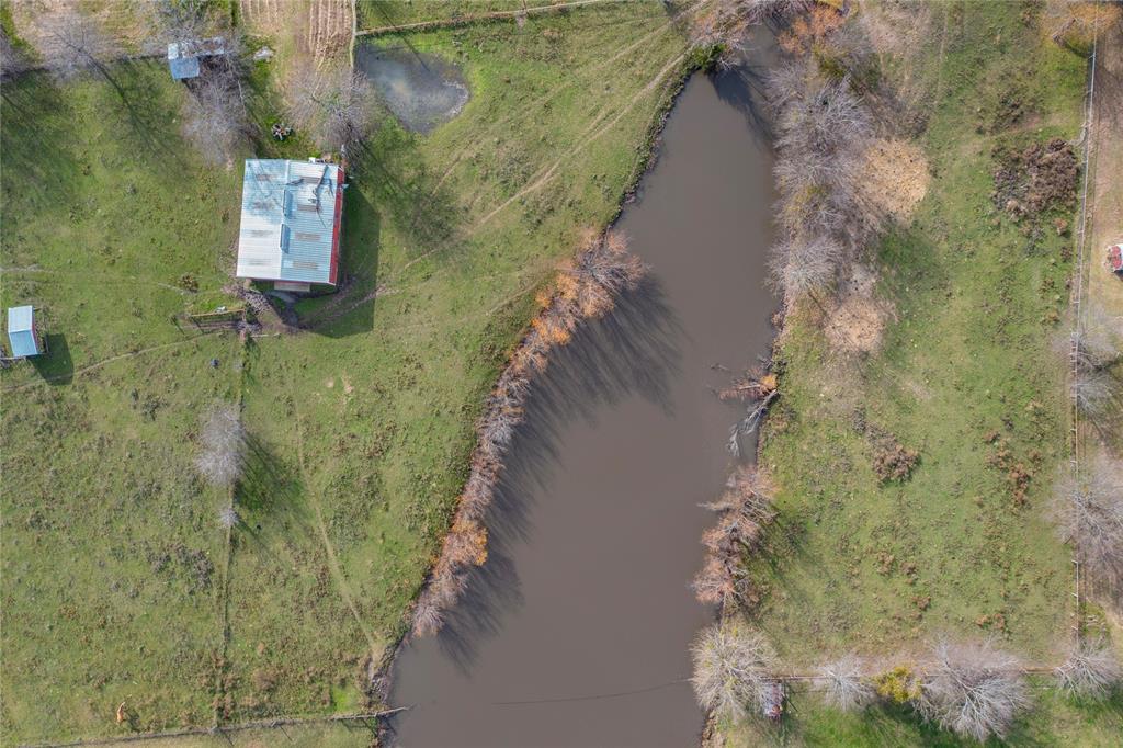 Beautiful 20 Acres, pipe fencing from barn area to frontage road FM 148 cross fenced in 3 sections. Home has 4 bd 2 bth, 2 living, office. This property has so many amenities

Horse Barn 
60 ft.  X  48 ft.
6 Stalls
1 Foaling Stall
1 Tack Room
1 Wash Rack Area

Loafing shed 12 ft.  X. 24 ft.

Cutting Training Pen 
175 ft.  X  100 ft.
2 Cattle holding pens with loading chute
21 ft.  X. 24 ft.

Rodeo Roping Arena
275 ft.  X  180 ft.
Cattle return alley
2 Cattle holding pens 45 ft  X. 33 ft.
2 Roping Boxes 18 ft.  X. 15 ft.

Shop Building  
40 ft. X. 60 ft.
Fully covered metal awning attached to side of shop completely concreted for vehicle parking 
60 ft.  X  72 ft.
