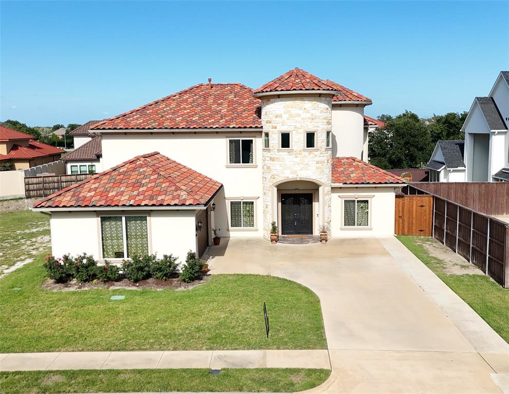 Custom Built Mediterranean Masterpiece—experience timeless elegance in this stunning custom-designed 5-bedroom, 4-bath home situated on one of the largest lots in the community. From the moment you enter through the grand cast iron front door, you are welcomed by soaring 20-foot ceilings, abundant natural light, and graceful architectural arches that enhance the open-concept design. The impressive family room features a dramatic 20-foot ceiling, expansive windows, and custom decorative brickwork, while a striking curved staircase and solid hardwood flooring add to the home’s sophisticated charm. Hardwood floors extend throughout the main level, excluding the kitchen and guest suite. The gourmet kitchen is a chef’s dream, complete with a 48-inch commercial-grade range with vent hood, custom cabinetry, a large stainless steel farmhouse sink, and 2cm granite countertops, which are also featured in all four bathrooms for a cohesive upscale finish. The thoughtfully designed layout includes two bedrooms on the main floor, including a spacious primary suite and a guest bedroom, offering both comfort and convenience. Additional highlights include 8-foot interior doors, a tankless instant water heater, extended front parking, and a stunning six-color Spanish brick tile roof accented with two decorative domes.
Garage flooring upgraded with Epoxy, also a Tesla wall charger is installed for your convenience!