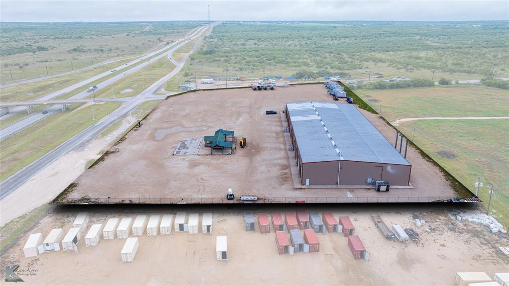 Prime location on Interstate 20 in Abilene TX, this Eula metal fabrication shop is for sale & ready for a fabrication company to set up shop! This property is 5.57 acres with 12 inch caliche base on the lay down yard. Shop office includes two large offices with employee break room with central heat & air. The 23,680 sq. ft. shop has a 25 ft ceiling, LED lighting, 1500 amps of power (480, 3 phase), six cranes 5 tons each, 50 ft x 100 ft paint booth area, air compressor - 50 horse Ingersoll Rand. The large shop also has 8 doors of various heights and widths, large tool room with central heat & air. There are security cameras (7 cameras inside the shop & 4 outside).  There is also separate, large concrete slab in the yard that is 1,960 sq ft and 48 inches thick. The log cabin office building on the property has two offices, 480 sq. feet, ceiling fans & two wall AC units.