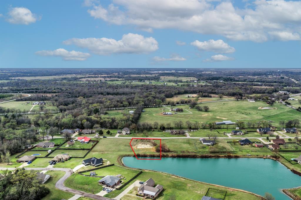 Welcome to an exceptional homesite in the desirable Honeysuckle Creek Subdivision, where natural beauty, privacy, and convenience come together to create the perfect setting for your custom dream home! This premium lot offers a rare and tranquil feature, partial lake frontage along the back of the property, providing a stunning natural backdrop and a peaceful atmosphere that elevates everyday living.

Dirt work has already been started, giving you a head start toward bringing your vision to life. With no HOA, no leaseback requirements, and light deed restrictions, this property offers the ideal balance of freedom and quality surroundings within an established, well kept community.

Despite its quiet, country like setting, the location is remarkably convenient. Downtown is just minutes away, placing shopping, dining, and local amenities within easy reach. A brand-new elementary school currently under construction nearby further enhances the desirability and long-term value of this location.

Opportunities to build in a setting that offers water access, privacy, and close proximity to town are becoming increasingly rare. If you are seeking a refined homesite where you can design a residence that reflects your lifestyle while enjoying the serenity of nature, this property presents an exceptional opportunity!