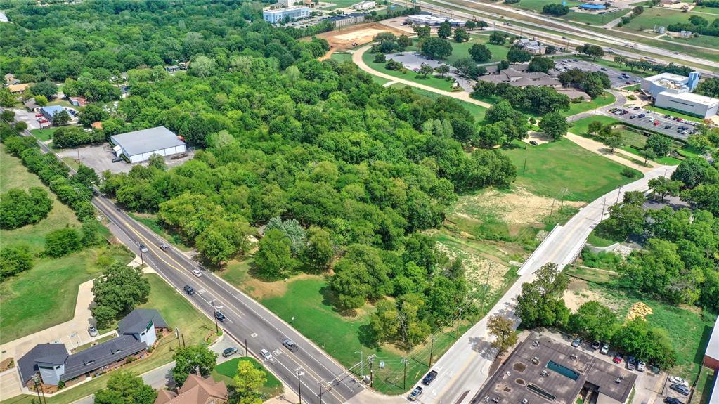Where community, commerce, and convenience meet in Sherman. Positioned at the signalized intersection of North Travis Street and West Lamberth Road, this high-visibility VPD +-18,000 (Travis and Lamberth combined) parcel presents a premier development opportunity in the heart of Sherman, Texas. The 2.39-acre site (1.904 acres net usable) which pricing is based on is fully serviced with city utilities and located within a Qualified Opportunity Zone, offering exceptional long-term investment incentives. Strategically situated in a rapidly growing corridor surrounded by residential development, schools, and retail anchors, the property is ideally suited for a range of neighborhood-focused uses, including retail, QSR, boutique medical, and office-flex formats.