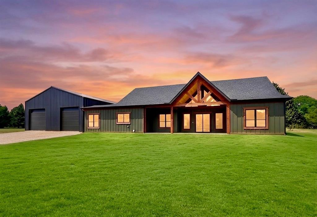 Don’t follow GPS - see driving instructions. Modern Bardominium under construction on 3.544 acres with a guest house and 40x80 barn that also serves as the garage with 4 garage doors - two in front, two in back. Experience elevated country living in this stunning custom home built for comfort, efficiency, and style. Main house has 2600 sq. ft. Step into the spacious living area with a breathtaking vaulted ceiling finished in decorative ponderosa pine, complemented by a striking stone modern fireplace and sealed concrete floors throughout. A massive 12-ft sliding glass door opens to the outdoor living space, while the exotic 6x8 pivoting front door makes a bold first impression.The chef’s kitchen is a true centerpiece, featuring an impressive 11-ft island, custom walnut cabinetry, quartz countertops, and a 48” commercial gas stove with oven. A dedicated coffee bar and dining area add both function and charm, along with custom sinks and designer faucets. Large walk in pantry. Primary bedroom split from other bedrooms and features a stand alone tub and separate shower with large walk in closet. Two other huge bedrooms with walk in closets, private study. Large laundry room - mud room combo. Outdoor features are just as impressive, with three covered back patios featuring decorative ceilings—perfect for relaxing or entertaining. Custom dog run with turf. Two story guest house with living-kitchen, bedroom and full bath and its own private patio. For energy efficiency,  this home features spray foam insulation and Zip System sheathing on both the exterior and roof for superior energy performance.Fresh water well providing endless, great-tasting water. No city taxes! Completion date end of July. This one-of-a-kind property combines luxury, functionality, and room to grow—don’t miss your chance to make it yours. Photos are virtually enhanced, home still under construction.