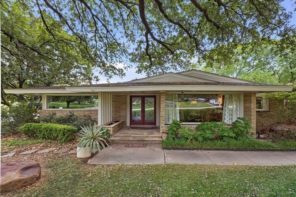 Don’t miss this one of a kind home in a great area close to TCU, shopping, and walking trails. Situated on a wonderful street, this home offers abundant natural light and a very private setting on a large corner lot with mature trees. The living room overlooks a charming courtyard, creating a peaceful and inviting space for relaxing or entertaining.
The backyard backs up to a greenbelt and features a pool and sport court. Inside, you will find marble flooring in the entry and office, custom lighting, and walls of windows throughout.
The home offers 3 bedrooms and 3.5 baths, plus an additional separate bedroom, office, or pool house with a full bath that is not included in the square footage, ideal for guests, a home office, or flexible living space.
