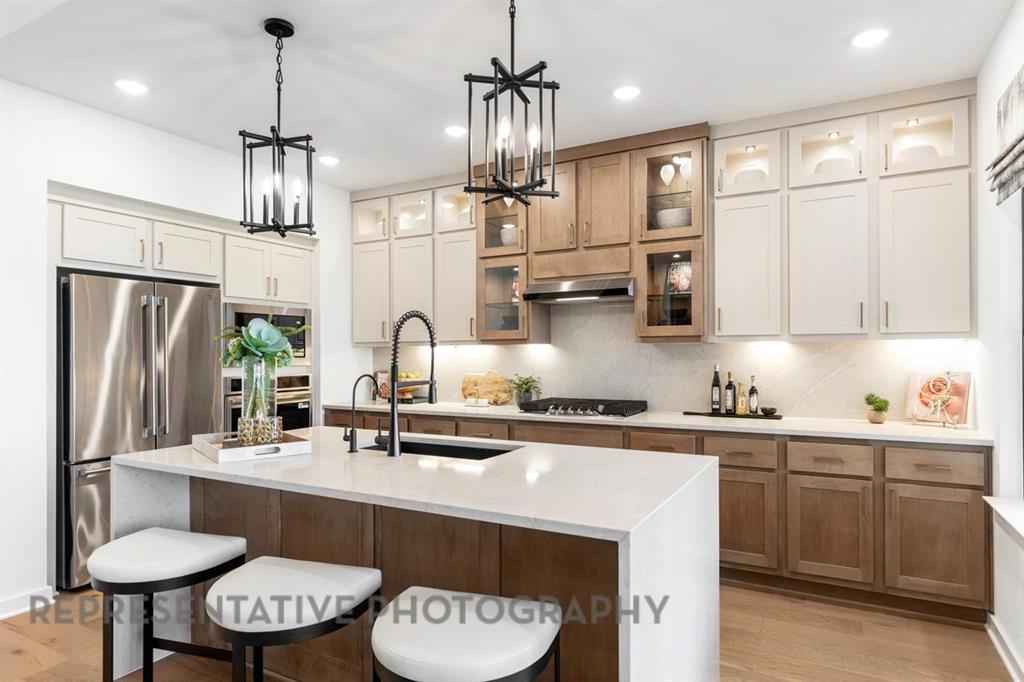 This exquisite two-story home offers over 2,700 sq. ft. of thoughtfully designed space. A striking modern exterior welcomes you with light brick and covered front entry with a cedar garage door. Inside, the open dining and family rooms boast vaulted ceilings, a gas fireplace, entertainment room, and covered patio which accommodates private relaxation or large gatherings. The heart of the home impresses with a chef-inspired kitchen. Retreat to the secluded spacious primary suite, offering a spa-like bath with a soaking tub, separate shower, dual sinks, and a walk-in closet.