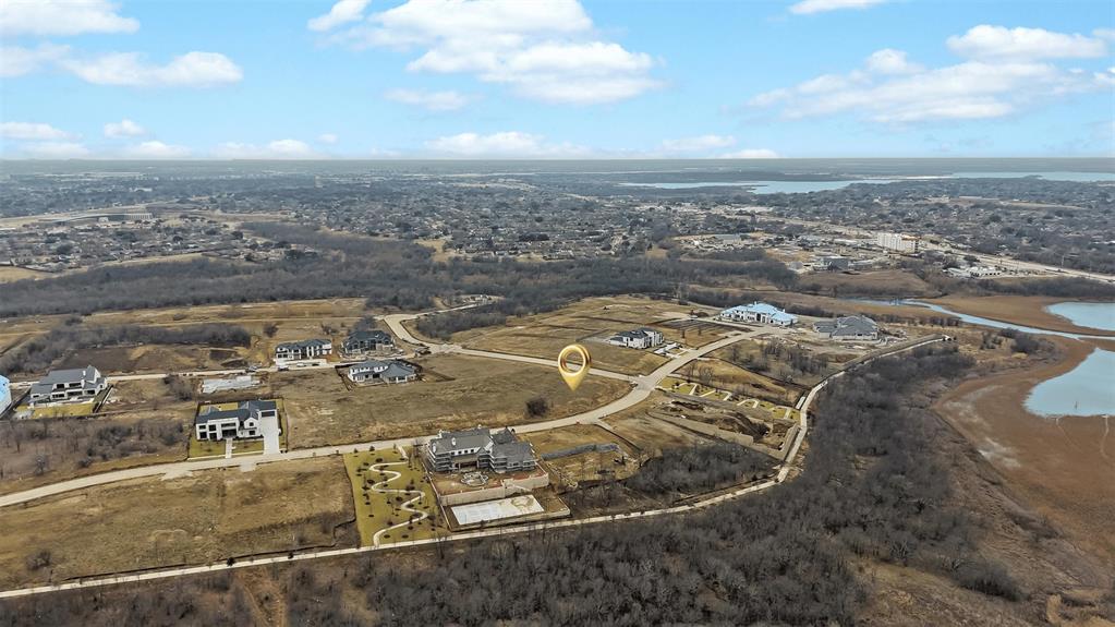 Rare opportunity to own a premier corner estate lot just under one acre (0.916 acre) in the guard-gated Hills of Kingswood. Choose your builder! Situated at the intersection of Lilac Lane and Midora Lane with views of the lake, trail and creek, this expansive homesite offers exceptional design flexibility—ideal for creating a one-of-a-kind custom estate with ample space for a resort-style pool, sport courts, outdoor living, and manicured grounds. Nestled in the heart of Frisco, this coveted location provides quick access to The Star, Legacy West, PGA Headquarters, Stonebriar Centre, Lewisville Lake, and the tollway. A perfect blend of privacy, prestige, and proximity to world-class amenities.