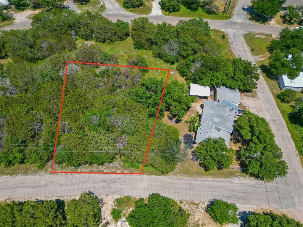 Rarely-Available Vacant Residential Lot with Mature Trees! Tucked away in the sought-after community of Oak Trail Shores, this 0.123-acre lot ensures versatility for both prospective homeowners and investors. Ideal as a vacation spot or an everyday residence, the parcel may be upgraded with a single-family home or a manufactured residence. Shaped to accommodate outdoor entertaining, the lot has ample room for creative site planning with patios, decks, landscaping, or even a hot tub. Thoughtfully designed for vacationers and residents, the community offers access to amenities, such as a pool, two parks, boat ramps, basketball court, soccer field, fishing pier, and a community center. After enjoying a blissful day with loved ones and neighbors, take a 4-mile drive to Downtown Granbury. Sip local delights at the wine bars, buy trinkets at boutiques, or dine at one of the many restaurants. Don’t delay becoming a resident of this outstanding community! Private seller fin. is available with large down payment for deserving borrowers.