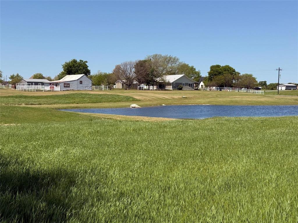 Experience peaceful country living on this beautifully appointed 12-acre ag-exempt ranch. Set among mature oaks and open pastures, this property offers a stocked pond, orchard, irrigated garden, barn with water and electricity, large equipment shed, carports, storm shelter, and pipe fencing with cross-fenced pastures for horses or cattle.

The custom farmhouse was completely rebuilt in 2019 with timeless style and modern efficiency. Inside, you’ll find an open layout with oak floors, LED lighting, and handcrafted details throughout. The kitchen shines with solid maple cabinetry, granite countertops, a large island, and farmhouse sink. The primary suite offers a spa-inspired bath with radiant heated floors, air jet tub, oversized glass shower, and a spacious walk-in closet.

Relax on the wide front porch, watch the sunset over the pond, and enjoy the best of country living just minutes from town.