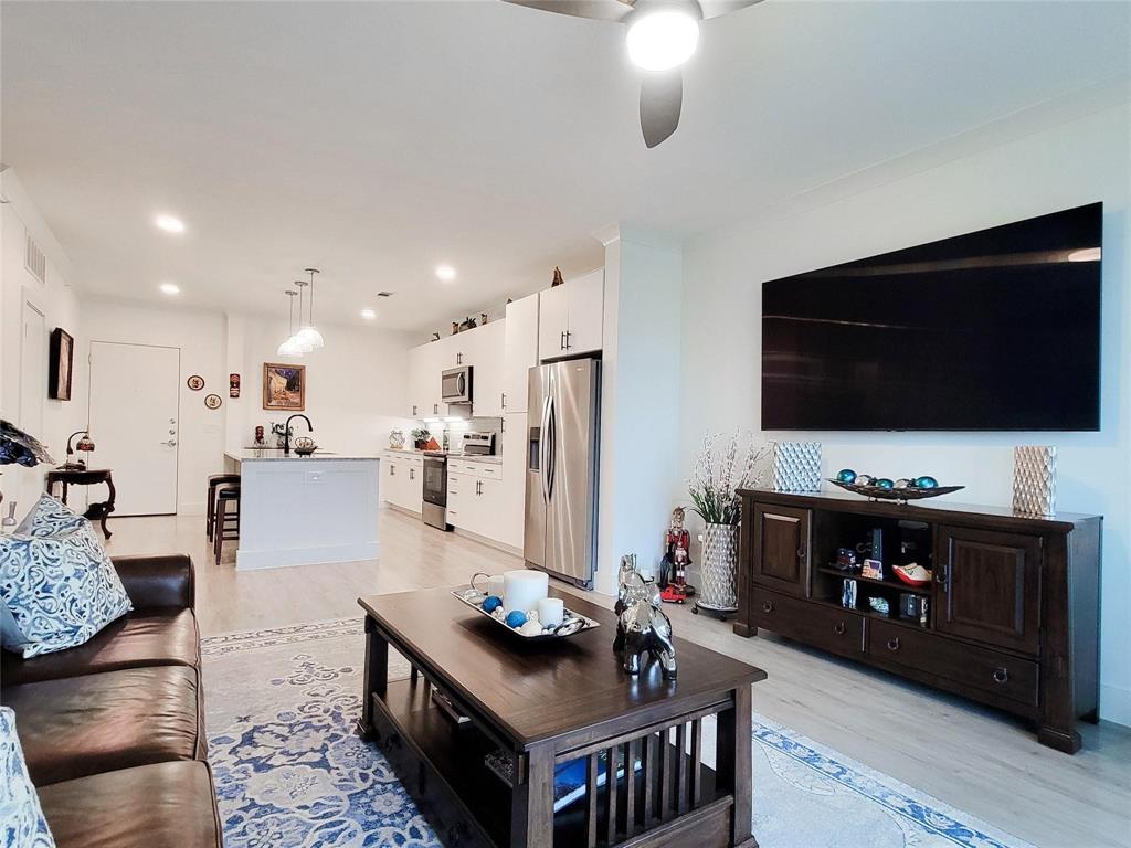 This property includes storage, garage, fridge, washer, dryer and giant TV! Experience luxury living at Sojourn at The Realm in the sought-after Castle Hills community! This beautifully appointed 1-bedroom, 1-bath condo offers thoughtfully designed living space with upscale finishes throughout. The open-concept floor plan is flooded with natural light and features luxury vinyl plank flooring in the main living areas and plush carpeting in the bedroom.

The gourmet kitchen impresses with granite countertops, a subway tile backsplash, stainless steel appliances, designer pendant lighting, and a generous island with seating, perfect for everyday living and entertaining. The spacious primary suite includes a large walk-in closet with washer and dryer hookups for added convenience. The spa-inspired bathroom features dual sinks, granite counters, and a walk-in shower.

Step out to your private covered balcony and enjoy peaceful views of the community. Additional highlights include one garage parking space, one covered parking spot, a private storage unit, valet doorstep trash service, and a secure camera-monitored lobby. HOA covers front yard maintenance, grounds upkeep, pest control, and trash service.

Ideally located just south of the Sam Rayburn Tollway at Windhaven and Castle Hills Drive, minutes from Grandscape, The Realm shopping and dining, and with quick access to SH-121, I-35, and the George Bush Turnpike. DFW International Airport is approximately 20 minutes away. Zoned to Lewisville ISD. Low-maintenance living at its finest, do not miss this one!