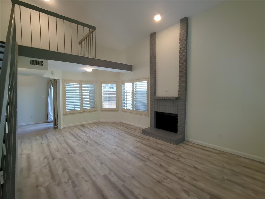 Beautiful and updated two story condo in gated community.  Located in Far North Dallas near the Galleria mall and Addison.  Nice and open living area with fireplace off of dining and eat-in kitchen.  Primary bed downstairs and second bed upstairs with separate office area and loft.  Luxury vinyl plank flooring throughout except kitchen and bathrooms.  Kitchen features stone counter tops and stainless appliances.  Full size washer and dryer connections off kitchen.  Fenced patio off dining and covered patio off second bed upstairs.  One covered parking space included, #064.  HOA includes water, trash, and community pool.