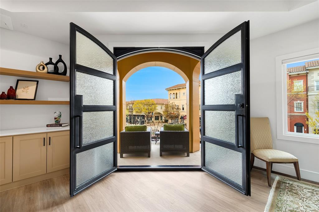 Welcome to The Residence at 62 Main Street, Unit 200. This fully renovated 4,070-square-foot second-floor retreat commands the entire level of one of the most architecturally striking buildings in the city of Colleyville. Tuscan-inspired stonework, arched loggias, and ornamental iron balconies frame a streetscape that feels pulled from the Italian countryside, yet you are steps from the heart of Colleyville's Village, minutes from DFW International Airport, and zoned to the acclaimed Grapevine-Colleyville ISD.

Inside, a designer kitchen anchored by a waterfall quartz island, luxury appliances, and a dedicated prep pantry flows into an entertainment-scaled living room with a fireplace and built-in wine bar. The primary suite is a private wing with its own fireplace, French doors opening to an arched balcony overlooking the Village, and a spa-caliber bath featuring a freestanding soaking tub and floor-to-ceiling marble shower with gold fixtures. Three additional en-suite bedrooms, full-size laundry with pet wash station, and a two-car attached garage complete this singular offering.

Smart home integration includes in-ceiling speakers wired for Sonos, automated blinds, and biometric building entry. Individually zoned climate control provides precision comfort throughout. Elevator access throughout the building. HOA amenities include a resort-style Mediterranean pool and fully equipped fitness center. Resort living without the resort commute.

Walk to live concerts in the town square, boutique dining, spas, shopping, and the library, all from your front door. This is lock-and-leave living at its most elevated. For those who know the world's greatest cities and are ready to bring that standard home.