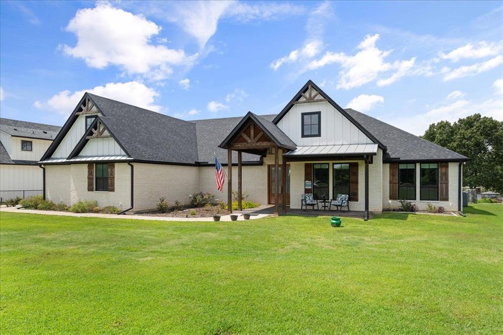 Purchase just in time for unforgettable summer lake activities on the shores of Lake Fork!! This one-of-a-kind custom lakefront retreat seamlessly blends elevated design, sophisticated finishes, and the relaxed beauty of lakeside living....
Thoughtfully crafted with a desirable split-bedroom layout for added privacy, this stunning 4-bedroom, 2.5-bath residence welcomes you with an expansive living area featuring striking faux wood beams, a remote-controlled ventless fireplace, and custom built-in shelving that create a warm yet refined atmosphere perfect for entertaining or peaceful evenings at home.
The chef-inspired kitchen showcases dual ovens, an oversized island, abundant cabinetry, generous prep space, and a spacious walk-in pantry complete with a dedicated coffee bar. Elegant glass-front display cabinets offer the perfect space to showcase your favorite dishes. The screened sun porch offers the ideal year-round setting to relax while overlooking the fenced backyard and private boat dock, fully equipped with electricity, fishing ports, and ample space for boating, fishing, entertaining, and enjoying endless summer days on the water.
Retreat to the serene primary suite, beautifully enhanced with custom wood ceiling details and private access through a sliding barn door leading into a spa-inspired bath. Indulge in the clawfoot soaking tub, oversized walk-in shower, dual vanities, and expansive walk-in closet that also functions as a reinforced storm room for added peace of mind.
The secondary bedrooms continue the home’s custom luxury feel with designer shiplap accents, paneled feature walls, and distinctive finishes that add warmth, charm, and character throughout.
Additional highlights include a spacious three-car garage with premium epoxy flooring and an unfinished bonus space above—perfect for future expansion, a private guest suite, game room, studio, or home office.
Step outside and embrace the ultimate lakefront lifestyle.