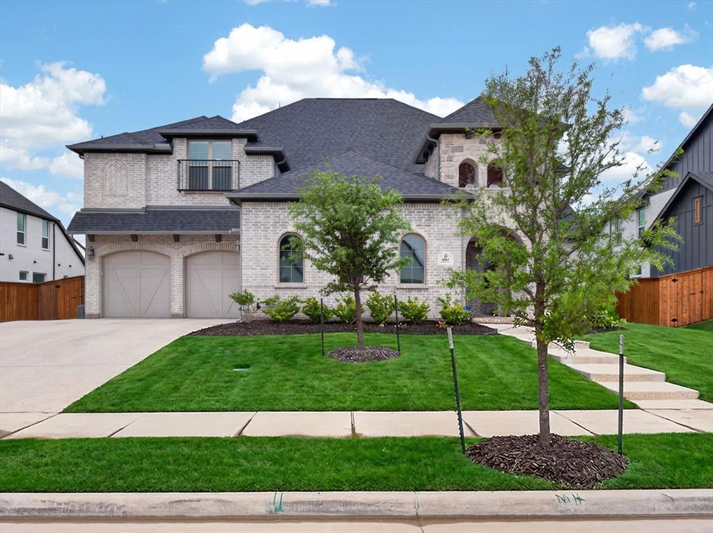 Nestled in the Reagan section of Light Farms, loaded with builder and owner upgrades throughout, this two-story home offers 5 bedrooms with en-suite baths and walk-in closets. An 8' mahogany front door and stone elevation open to a soaring two-story entry with spiral staircase and a private study with French doors and a dedicated exterior entry. The open-concept living area and formal dining room centers on a floor-to-ceiling painted brick fireplace, with custom built-in cabinets and open shelving framing both sides, with a second fireplace anchoring the casual dining space. The chef's kitchen is a showpiece with a waterfall premium slab island, statement backsplash, Blanco farmhouse sink, KitchenAid gas range-top with double ovens, custom cabinetry, under-cabinet lighting, and a wet bar nestled beneath the staircase. The primary suite is a private retreat with a freestanding soaking tub, frameless glass shower, extended vanities, makeup vanity, champagne bronze fixtures, and dual walk-in closets, each outfitted with owner-installed custom cabinetry and built-in shelving. A secondary en-suite just off the entry offers ideal accommodations for guests or multigenerational living. Three additional en-suite bedrooms, a game room, and a dedicated media room sconce-lit and prewired for surround sound and projector complete the upper level. Outside, a 25'x15.5' covered patio extends to an expanded travertine patio and an outdoor kitchen finished in matching brick, featuring a built-in grill, mini fridge, and pebble ice maker. Additional highlights include iron fencing, epoxy garage floors, oversized 8' garage doors, and a reinforced storm shelter sized to share the garage with a golf cart. Finishing touches throughout: nail-down red oak hardwood floors, solid oak stair treads, utility room with built-in cabinetry, a sink, and space for a refrigerator., smart deadbolt, LED lighting, and security. Zoned for Prosper ISD — Light Farms Elementary, Reynolds Middle, Prosper High.