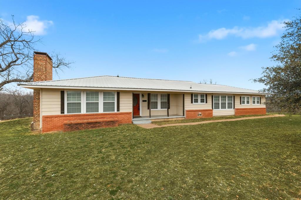 Spectacular 1 acre property with panoramic views overlooking Cottonwood Creek. This restored home features large rooms, a flexible floorplan, hard wood flooring in select areas. Spacious dining area and cozy fireplace create a welcoming gathering space. Enjoy scenic sunsets and wildlife from the rear deck. Major updates include a 2014 metal roof, new ductwork, insulation, vents, and blinds for improved comfort and efficiency. Fully fenced acreage offers privacy and room to roam, plus an attached 2 car garage for convenience. Easy access to Ennis and Kaufman provides the perfect blend of peaceful country living and commuter accessibility to Kaufman, Ennis and Dallas. Affordable acreage, Room for hobbies and outdoor living, If you liked to fish you  Cedar Creek Lake, Lake Bardwell and Lake Tawakoni are close by.