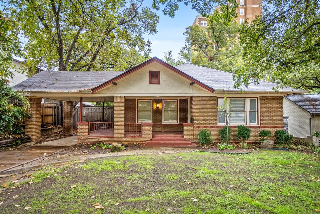 Step back in time with this inviting 3 bed one and a half bathe  home full of character and warmth! Located in one of Fort Worth’s most desirable areas, Mistletoe Heights, near the Fort Worth Zoo, Lily B. Clayton, TCU, and the vibrant cultural district, this 1924 Craftsman-style beauty offers timeless appeal and modern potential.
Inside, you’ll find original wood floors, large windows flooding each room with natural light, and a cozy living area with a classic brick fireplace. The kitchen showcases abundant wood cabinetry, a gas cooktop island, and built-in storage that adds to the home’s vintage charm.
Enjoy peaceful mornings or relaxing evenings on the wrap-around front porch, perfect for coffee or friendly gatherings. The spacious backyard features a decked patio ready for entertaining, mature shade trees, and a storage shed for all your tools or hobbies.
Additional highlights include a basement for extra storage or workspace, a long driveway with covered parking, and proximity to parks, restaurants, and entertainment. This home is a rare find offering old world craftsmanship with endless opportunities to make it your own in one of Fort Worth’s most iconic neighborhoods.