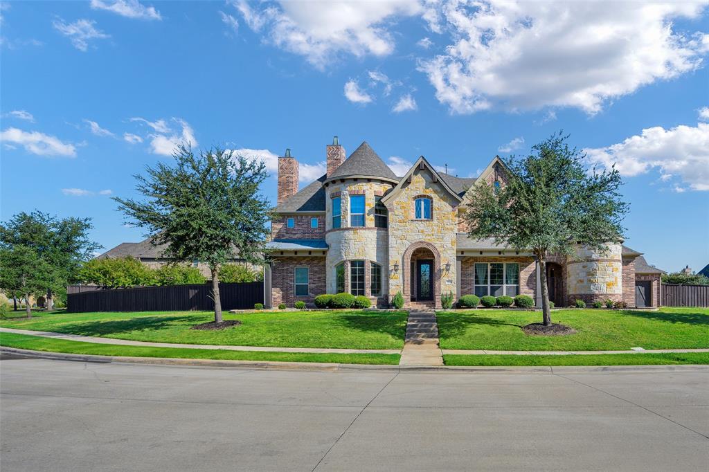 **Please have your agent schedule all showings with at least 12 hours advance notice. Thank you for your cooperation.**

Elegant and spacious, this stunning North Texas residence offers a rare blend of luxury, comfort, and architectural presence in the highly sought after Tribute Lakeside Golf and Resort community near Frisco. Featuring over 5,500 square feet of living space, the home makes a grand first impression with a dramatic double staircase, statement chandelier, and soaring ceilings filled with natural light.

Positioned on a desirable corner lot and surrounded by upscale homes, the property offers enhanced privacy and curb appeal while maintaining an open feel. Designed for both everyday living and entertaining, the open concept layout includes multiple living areas, a striking fireplace, and a chef inspired kitchen with an oversized island, ample cabinetry, and seamless flow into the main gathering spaces. Solid hardwood flooring adds warmth and durability throughout the main living areas.

Recent upgrades include an upgraded iron front door, updated tile in bathrooms, laundry room, and outdoor areas, along with an epoxy finished garage floor.

The home offers 6 bedrooms and 6 bathrooms, providing flexibility for families, guests, or multi generational living. The primary suite serves as a private retreat with dual vanities, a soaking tub, and a separate shower. Upstairs living spaces and balcony overlook the main level, adding to the open design.

Situated on nearly half an acre, the backyard offers plenty of space for outdoor living and entertaining. Residents of The Tribute enjoy resort style amenities including lake access, golf, trails, pools, and pickleball.

A rare opportunity to own a spacious, well positioned home in one of North Texas’ most sought after communities.

**Assumable VA loan available with approximately 2.7% interest rate for qualified buyers, offering significant savings compared to current rates.**