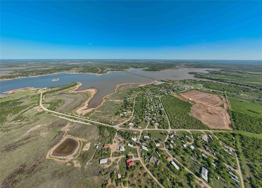 Waterfront opportunity on Hubbard Creek Lake! This .408-acre lot offers a cleared homesite with Ft. Griffin water meter already in place, electric available at the road, and an existing septic system (buyer to verify condition and usability).  The property provides direct access and proximity to the lake, making it an ideal setting for a weekend getaway, fishing retreat, or future homesite. The long, narrow layout offers flexibility for positioning a build while maintaining privacy from neighboring properties.  Located in an established lakeside community with easy road access, this tract combines affordability with the opportunity to enjoy lake living without starting from scratch.  Utilities and site prep are already in place—bring your plans and make it your own.  Affordable waterfront tracts with improvements in place are increasingly hard to find—don’t miss this one.