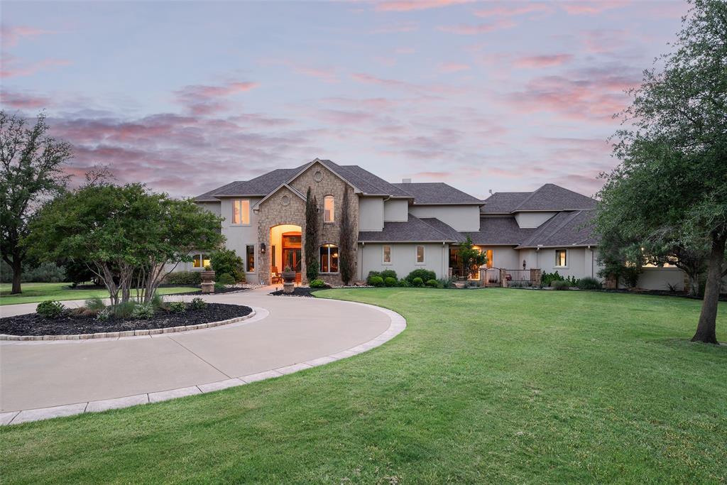 Welcome to an exceptional riverfront estate located in the exclusive community, Silverado on the Brazos. Positioned on 6.59 acres along the Brazos River, this impressive 7,410-square-foot residence offers the perfect combination of luxury, privacy, and resort-style living with stunning sunset views and direct water access.
Designed for both large-scale entertaining and everyday comfort, the home features expansive living spaces, a private office, a game room, a dedicated theatre room, and a private mother-in-law suite complete with a full kitchen, creating ideal accommodations for guests or multi-generational living. The gourmet kitchen is thoughtfully appointed with premium finishes, abundant prep space, and a reverse osmosis water system for added convenience.
The outdoor living experience is truly unmatched. Enjoy a sparkling pool and spa surrounded by lush landscaping, spacious patios, and panoramic river views. A built-in outdoor grill and multiple entertaining areas create the ultimate setting for hosting family and friends year-round.
For boating and water enthusiasts, the property includes a private covered dock complete with a sun deck, boat lift, and jet ski lift, providing easy access to the Brazos River. Residents also enjoy access to a community boat ramp within Silverado on the Brazos.
Additional features include a detached two-car garage with extra storage space for recreational equipment, hobbies, or additional vehicles. Whether you’re searching for a luxury primary residence, weekend retreat, or entertainer’s paradise, this property delivers a rare opportunity to experience upscale Texas riverfront living with space, privacy, and convenient access to the city.