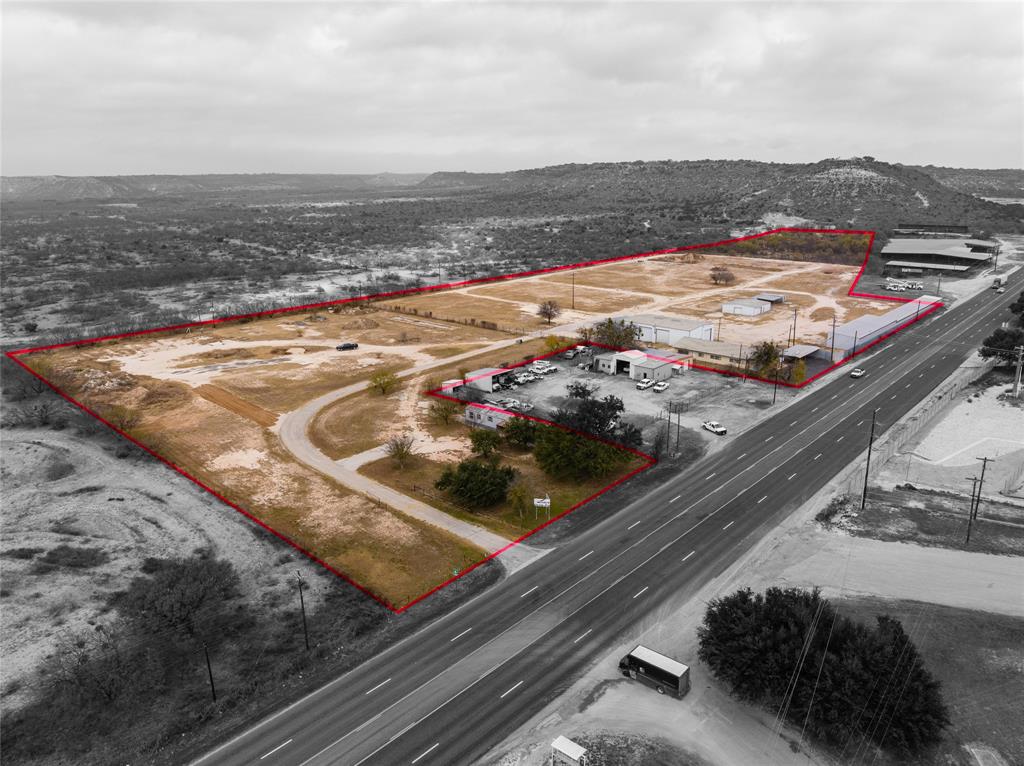14.49+ or -  0.8 MILES FROM I-10. Commercial Acreage that is perfect for any investors or an entrepreneur looking to start or house a business with great hwy frontage. Fully fenced & Crossed fenced. The property consist of an office building that is 2800 sqft with multiple office rooms, kitchen, 3 bathrooms, & covered parking attached to the office. Also on property is 2 detached covered parking buildings. One with 6 stalls and the other with 10 stalls. Directly behind the office is a large shop that is 3900 sqft. It has 4~ 16X25 roll up doors, 1~ 15X14 roll up door, corner office with a window unit, & 1 bathroom. Behind the Big Shop is a 1200 sqft, 3 bed 2 bath building that has been used for living quarters. There is another shop on property that is 2000 sqft. It has 3~10X8 roll up doors & has electricity.