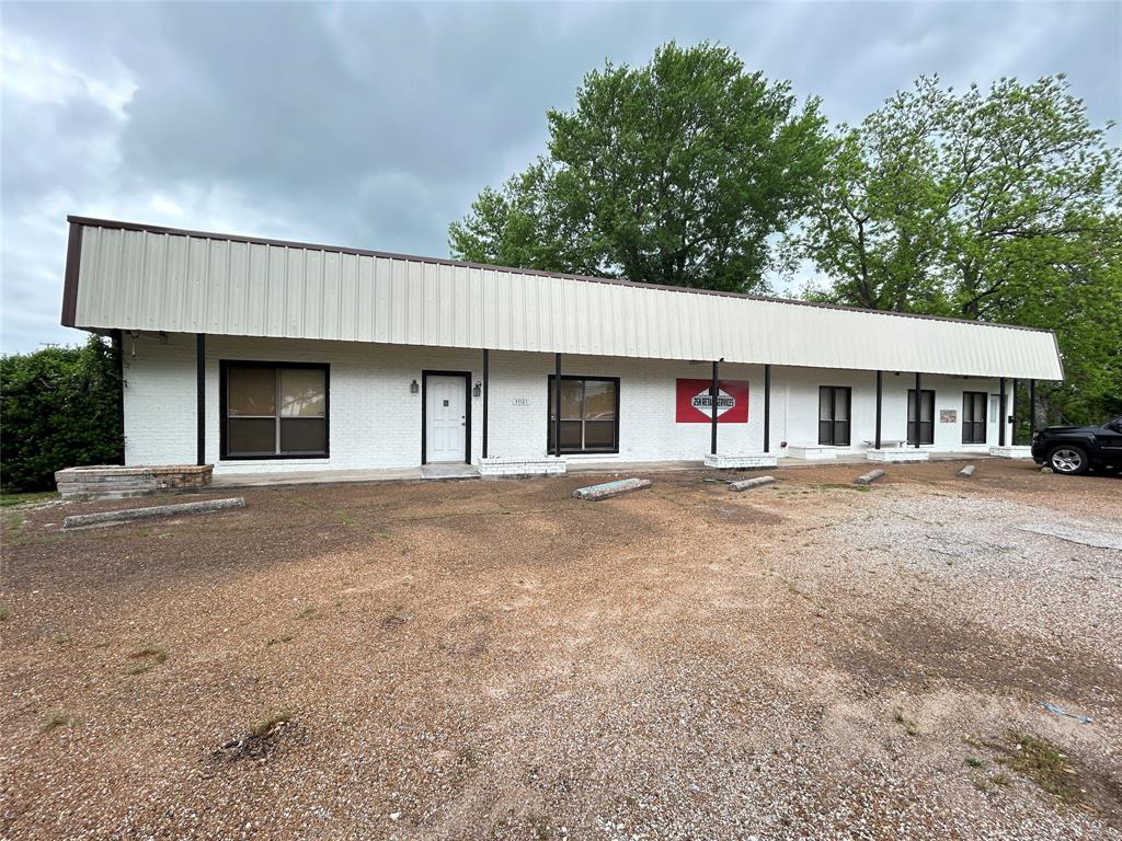 Downtown Commerce! Almost 1 acre lot with 3,000 square foot building (1,500 sqft office) with 2 half baths central heat and air with gas heat, security system, plus 1,500 square feet of warehouse that is ready to construct additional offices plus 11,000 square feet of  asphalt parking. This could be used for a number of things! Office furniture can stay if needed! Exterior is brick and metal.