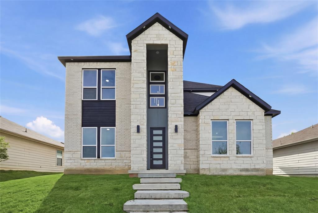 Step into this beautifully crafted 2026 new build featuring 4 bedrooms and 3 full bathrooms, thoughtfully designed for both comfort and style. The moment you enter, you’re greeted by soaring 20-foot ceilings in the living room, creating an open, airy atmosphere that feels both grand and inviting complete with a sleek electric fireplace that adds warmth and a modern touch. The living space flows seamlessly into the kitchen, where a striking waterfall island with Taj Mahal countertops serves as the centerpiece perfect for entertaining or everyday living. A dedicated dining area adds the ideal space for hosting dinners and gatherings. The first level also includes a spacious bedroom and full bathroom, making it perfect for guests or a private home office setup. Upstairs, retreat to the impressive primary suite featuring vaulted ceilings, a ceiling fan, and large windows that fill the room with natural light. The primary closet offers exceptional functionality with three levels of hanging space. The en-suite bathroom is designed for relaxation, complete with a double vanity, walk-in shower, and a soaking tub to unwind after a long day. Two additional bedrooms upstairs provide flexibility for family, guests, or work-from-home needs. Conveniently located near major highways, this home offers easy access to all that Dallas has to offer—shopping, dining, and entertainment just minutes away. Don’t miss your chance to own this modern, thoughtfully designed home, schedule your private tour today.