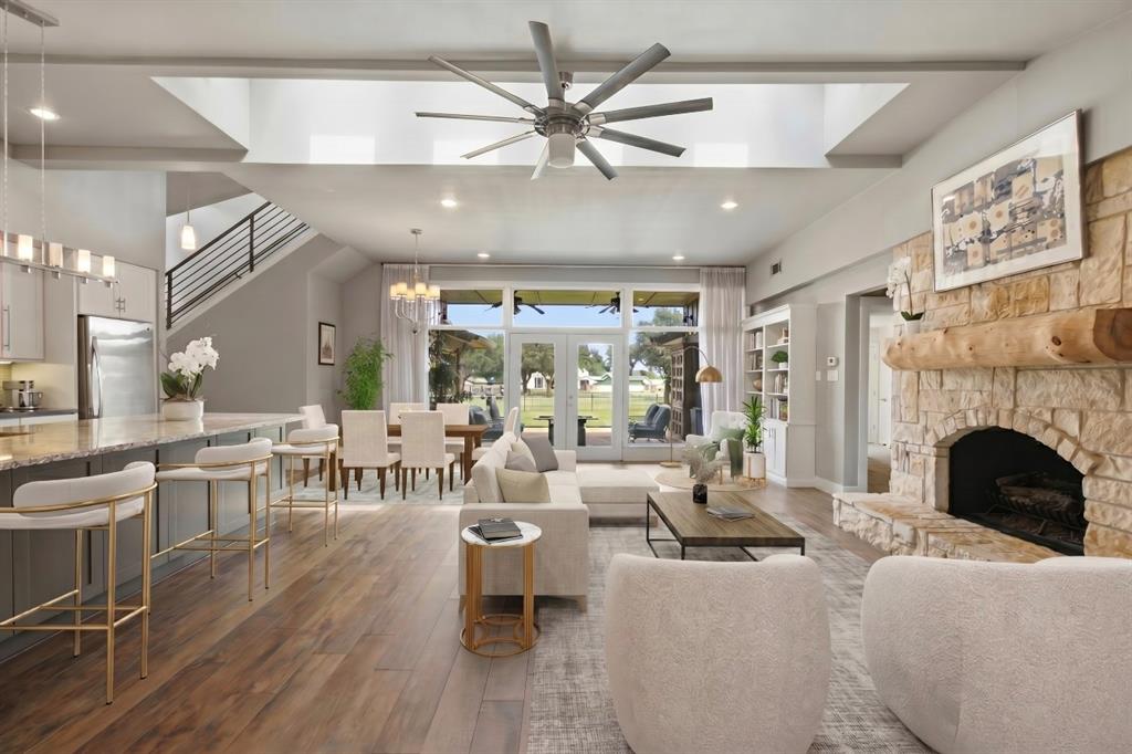 Experience refined golf course living in the prestigious Brookhaven Country Club. This beautifully renovated 4-bedroom, 3-bath residence offers exceptional style, comfort, and sweeping views of the Masters Course. The expansive living area is filled with natural light and features soaring vaulted ceilings with four skylights, and stunning golf course views that create a bright and inviting atmosphere. Designed for both everyday living and entertaining, the chef’s kitchen serves as the heart of the home with granite countertops, butcher block accents, oversized island, custom wine rack, and dedicated wine bar—all seamlessly connected to the main living space. Privately situated at the rear of the home, the spacious primary suite offers a peaceful retreat featuring an oversized walk-in shower, dual vanities, walk-in closet, dedicated shoe closet, and private water closet. Upstairs, the expansive fourth bedroom includes a full ensuite bath and walk-in closet, making it ideal as a guest suite. Offering incredible versatility, this expansive space includes a wet bar with a built-in mini refrigerator, making it an ideal second living area or game room. Step onto the private balcony to enjoy breathtaking sunset views overlooking the golf course. Located just a short golf cart ride or walk from the club, residents have access to optional country club membership amenities including golf, tennis, pickle-ball, swimming, fitness facilities, dining, and more. Furthermore, this home is located on the same power circuit as the local fire station, ensuring rapid power restoration during severe weather.