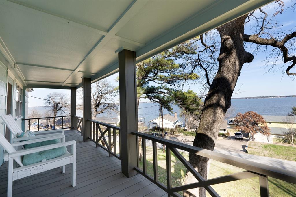 PRICE IMPROVEMENT!  Panoramic open water view! Well maintained lake house is nestled on a hill with mature trees, offers lots of shade, a panoramic open water view and an open concept layout. It features new appliances, quartzite counters, and new cabinets, providing ample storage and extra amenities including an oversized island which is perfect for entertaining and hosting family gatherings. Oversized bedrooms and closets provide plenty of space. Large windows throughout the house allow for an abundance of natural light, and spectacular water views. This house is move in ready and will make a great primary residence, vacation home or investment property. Additionally, the house is eligible for short-term rentals. The community offers a private boat ramp and a lake front common area for residents to use. Both refrigerators, washer and dryer are included. Furniture and contents package is also available. Please personally confirm school zoning.