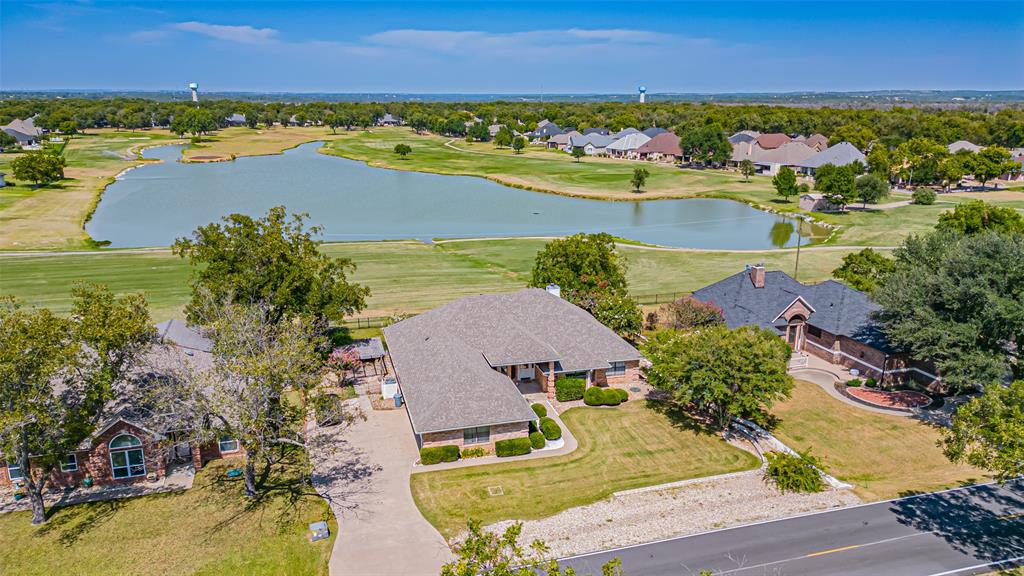 Experience refined living in this stunning golf course residence, perfectly positioned on a premium lot overlooking the prestigious Nutcracker Course and serene pond in the highly sought-after Pecan Plantation. Designed for both elegance and versatility, this expansive home features two gracious living areas, a sun-drenched solarium, and flexible spaces ideal for a private office, game room, or study. The open-concept layout is enhanced by a formal dining room, a charming breakfast nook, and three generously sized bedrooms. Exquisite custom millwork is showcased throughout, with built-in glass cabinetry in the kitchen and dining room, as well as finely crafted bookcases in the family room. Thoughtfully updated in recent years, this home offers modern comforts including a renovated kitchen, upgraded HVAC, hot water heater, iron fencing, pergola, and a brand-new roof. Beyond the home, Pecan Plantation provides an unparalleled lifestyle with 24-hour guarded gates, championship golf, tennis, swimming, equestrian facilities, fitness classes, river access, and a wealth of resort-style amenities.