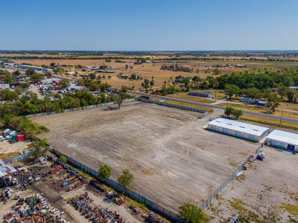 5 acre property with 3 metal warehouses 2 with heated and cooled office spaces. Property is fully fenced with solid metal fencing and gates. Highway 77 access and backs up to I35E just south of Waxahachie. And Just north of Hillsboro and the I35W split. Outside Waxahachie city limits. All buildings on property have leases 2 buildings on a 5 year lease and 1 on a 1 year lease.