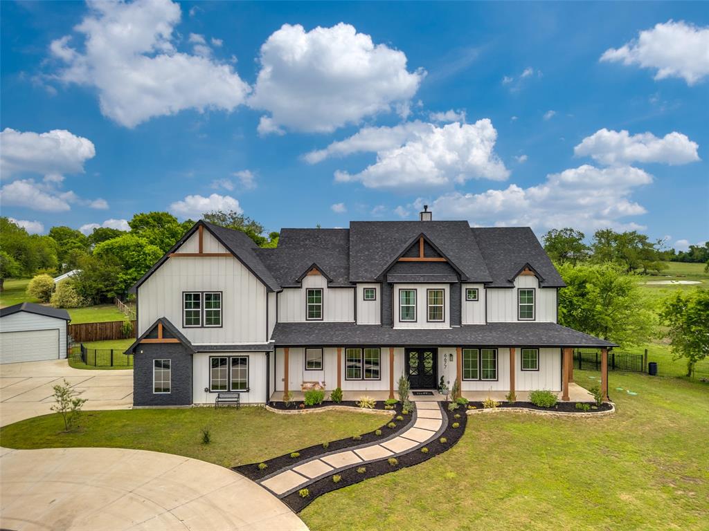 Come see this Gorgeous Custom Modern-Farm House on 7.541 ACRES - AG EXEMPTION available in the beautiful city of Farmersville, TX! This custom home offers 5 spacious bedrooms + office & bonus room for a 6th bedroom, 3.1 baths, 5 car garages and a game room with a climbing wall!! This property is absolutely breathtaking with views of agriculture, green space, pond, and the best Texas sunsets!! The owner recently added over $15K of landscaping, Jellyfish lighting, decorative lighting, and paint. Home has ample amounts of natural light and storage throughout. Upon entry is a grand foyer with office on the left, beautiful hardwoods throughout, and a two story living room with a beautiful floor to ceiling fireplace, vaulted ceilings, large windows, and open to the living and dining area. Gourmet dream chef's kitchen with large island, level 4 quartz, 66 inch Frigidaire built-in fridge, KitchenAid stainless steel appliances, custom cabinets, gas cooktop, double ovens, & a dining area that sits up to 12 people! Stately wraparound front porch and vaulted back porch with outdoor living and gas grill! The primary suite has a see through fireplace, huge tub for the best baths, double vanities, spacious shower, and custom closet. Upstairs has 4 large bedrooms one with an ensuite, bonus room-6th bedroom or gym, storage closets, an unfinished attic space, and a 22x32 game room with a climbing wall. Additional upgrades in the home are the radiant barrier roof deck for energy efficiency, home and patios wired for speakers, and game room for home theatre + surround sound. Fiber internet, ethernet ports at all TV locations, driveway has painted pickleball lines, 20x30 detached garage with power, lights and a 16x8 overhead door!! 50A charger in garage for electric vehicles. The backyard is fully fenced with outdoor lighting, fire pit, built in grilling area and extended patio. This is country living at its finest and conveniences all in one exceptional property in Collin Co!!